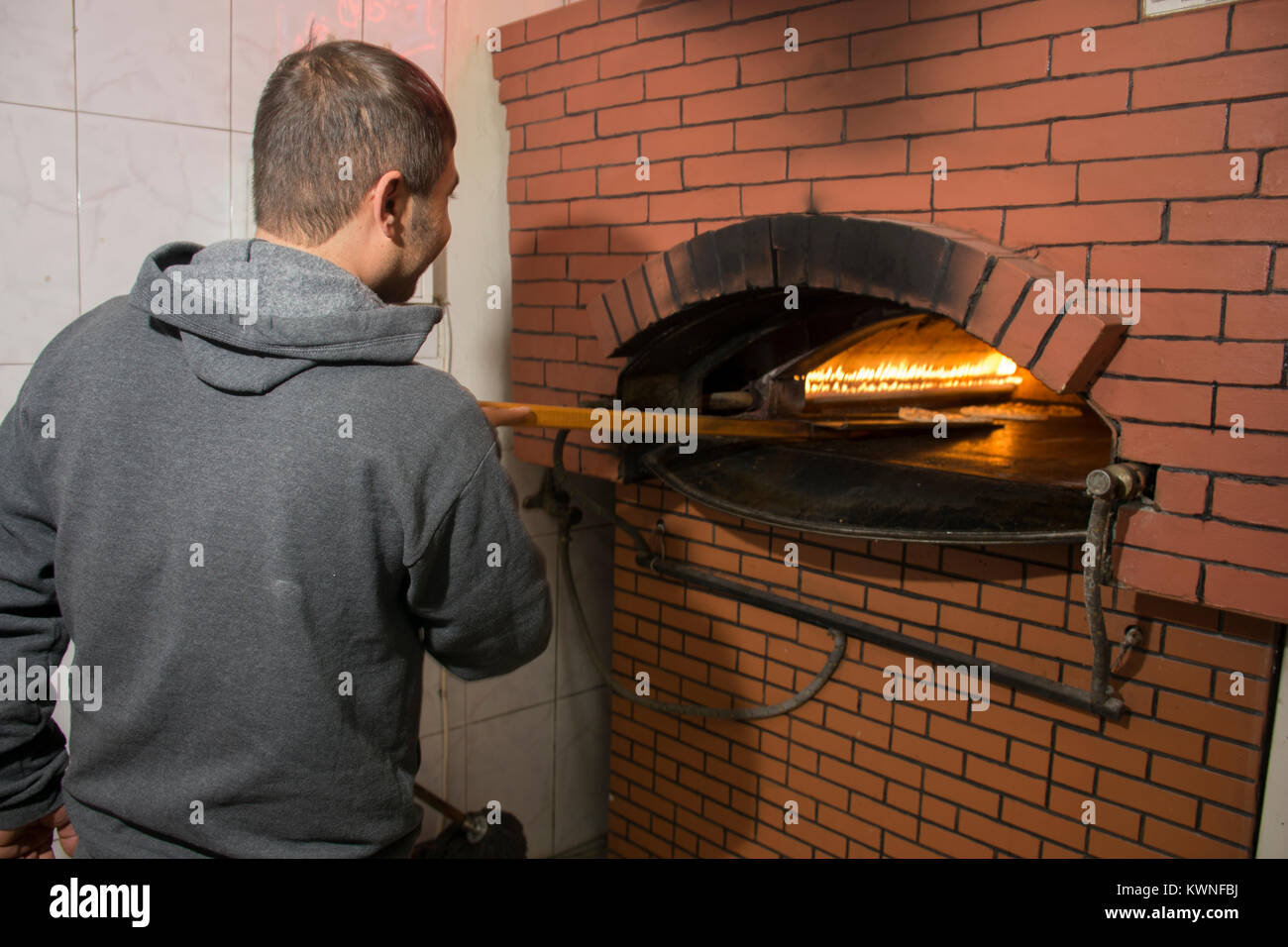 Man working inside a bakery Stock Photo