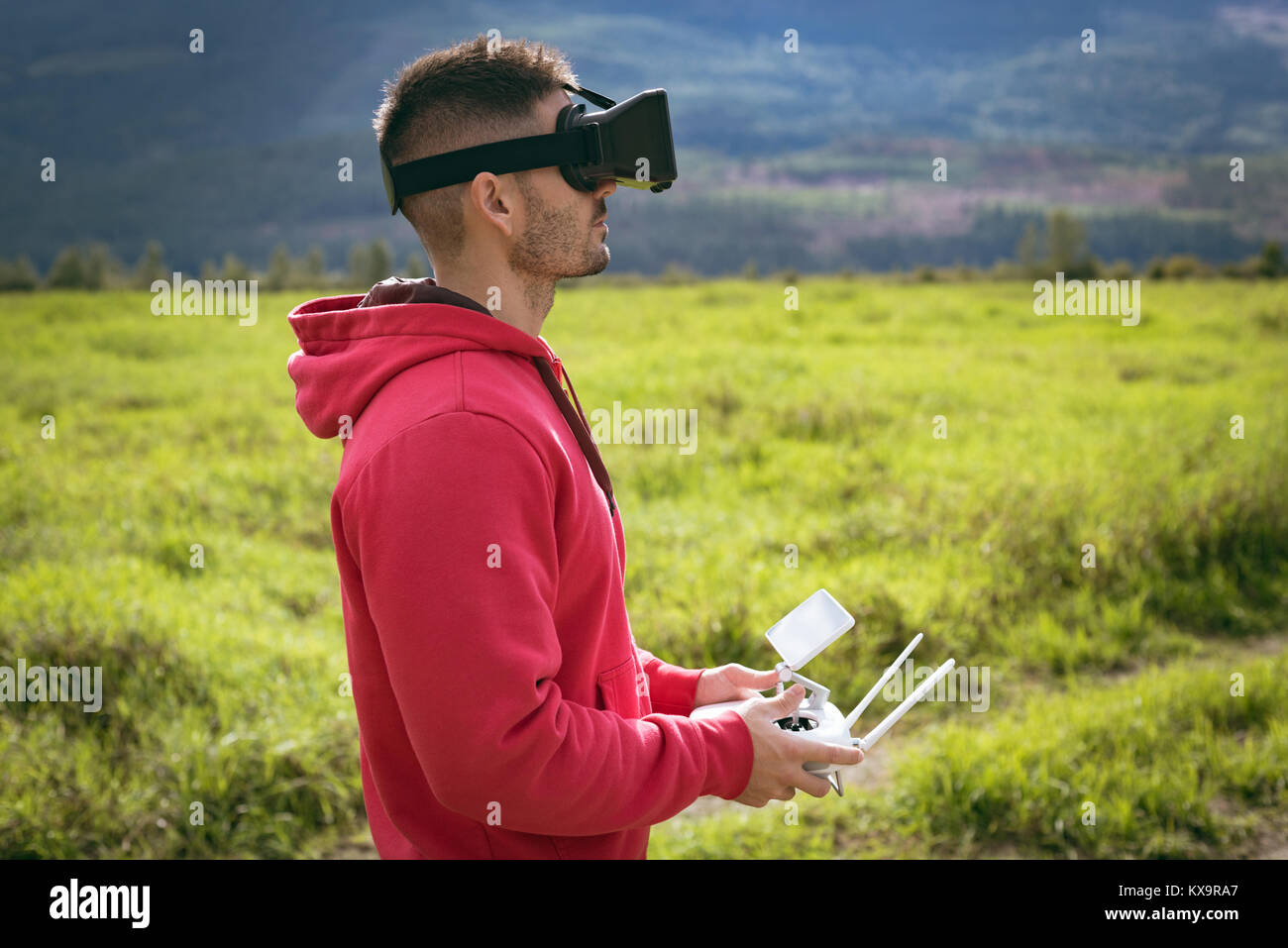 Man wearing virtual reality glasses and controlling drone Stock Photo