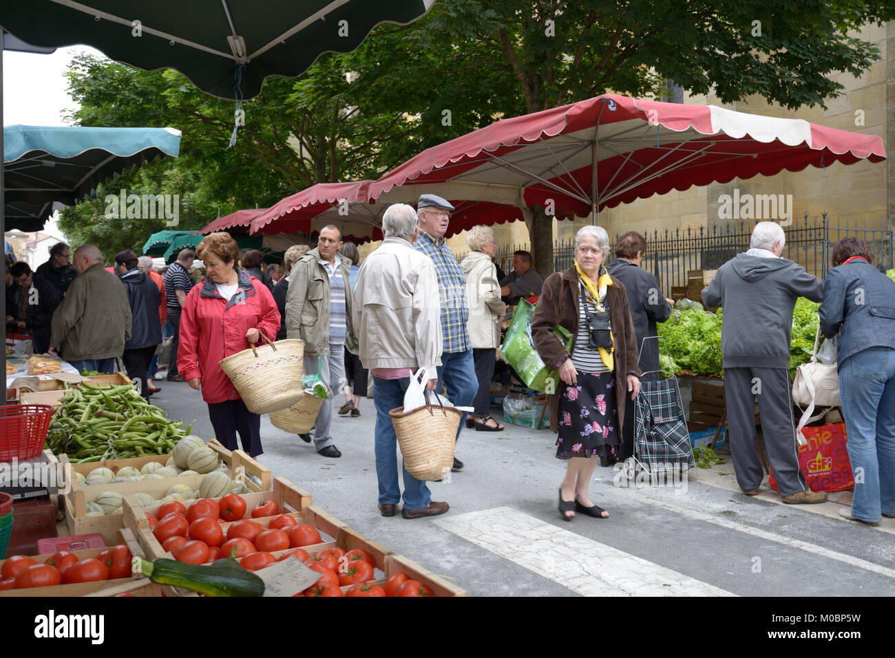 Bergerac, France - June 29, 2013: People on the street farmers market on the Market square. Farmers market near the Notre Dame church is open every We Stock Photo