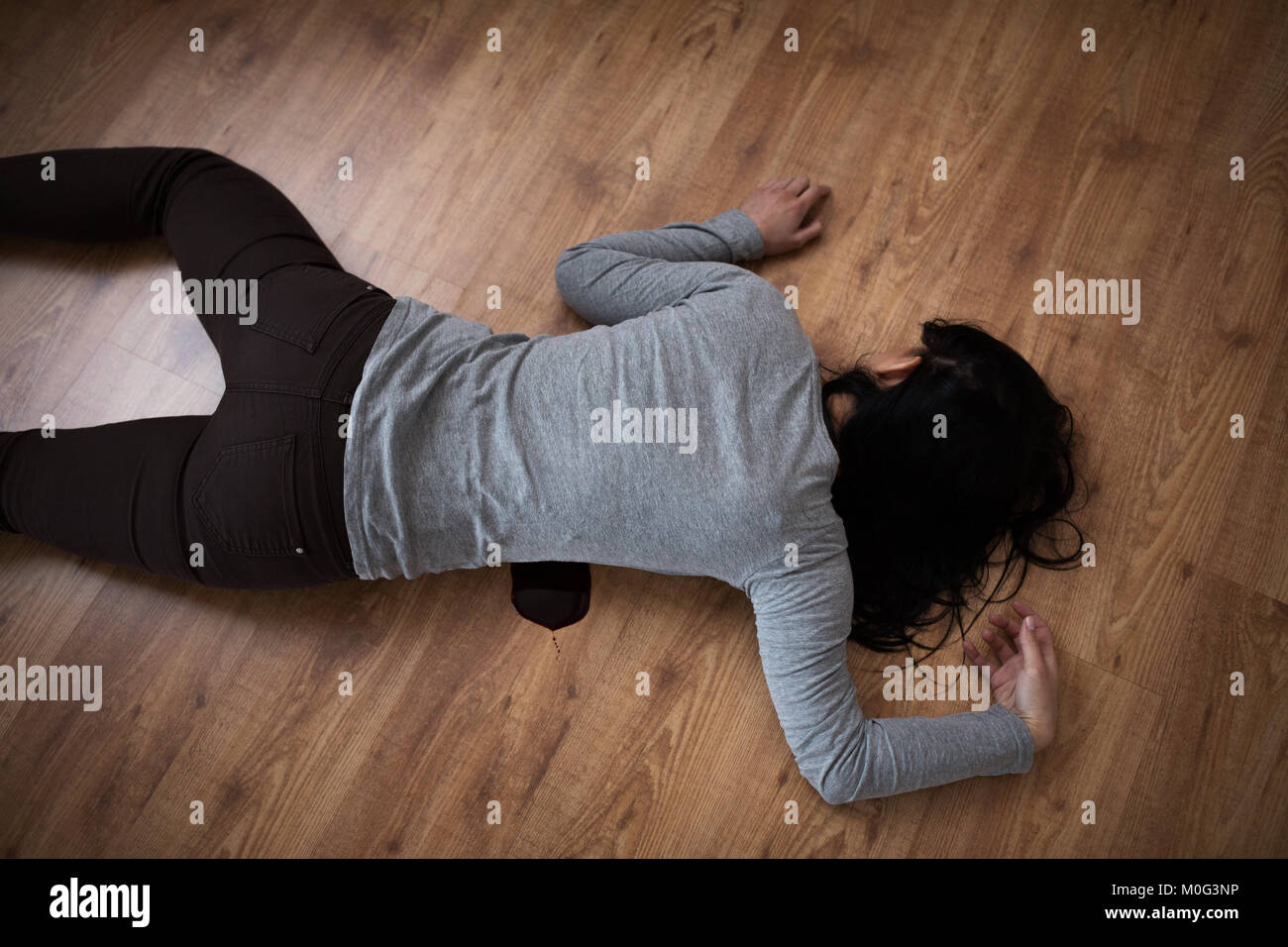 dead woman body in blood on floor at crime scene Stock Photo