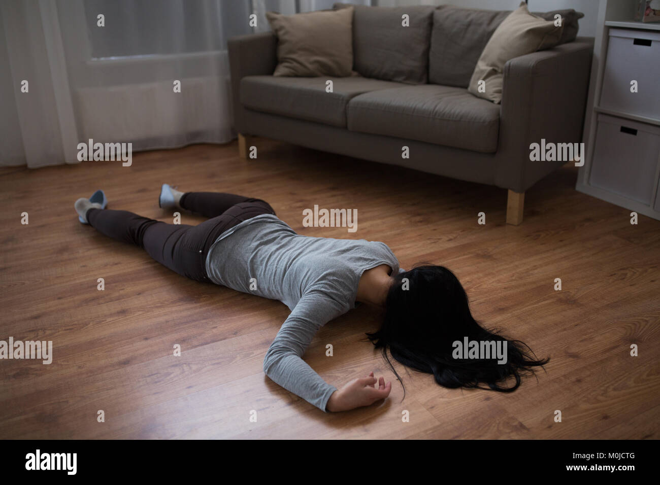 dead woman body lying on floor at crime scene Stock Photo