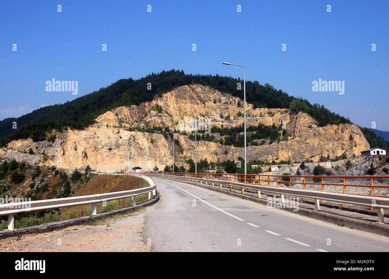 Road to stone pit on mountain landscape Stock Photo