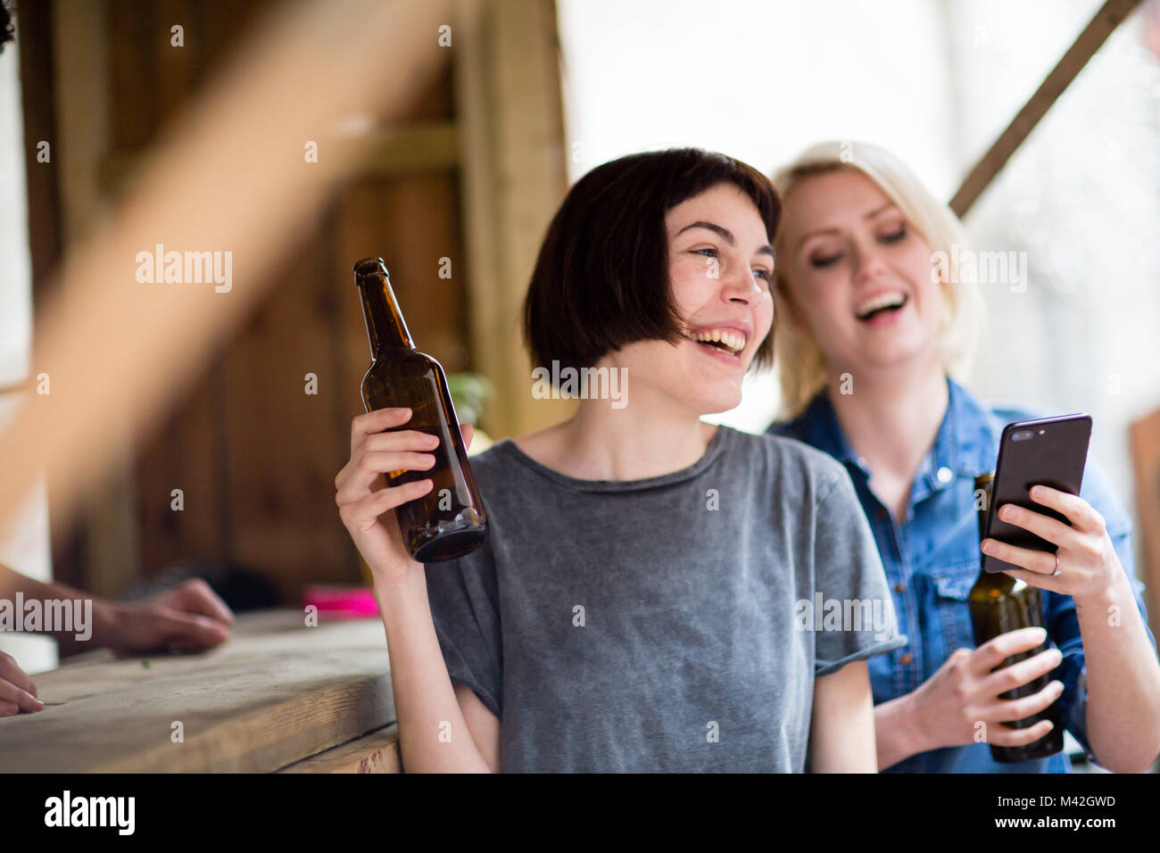 Two friends at a street food bar drinking beer Stock Photo