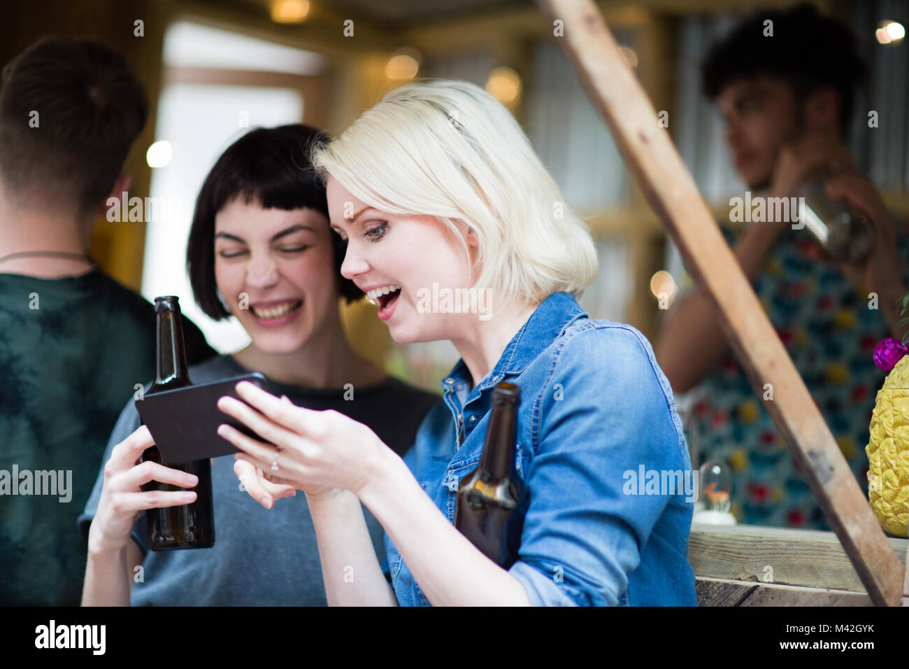 Two friends at a street food bar drinking beer Stock Photo