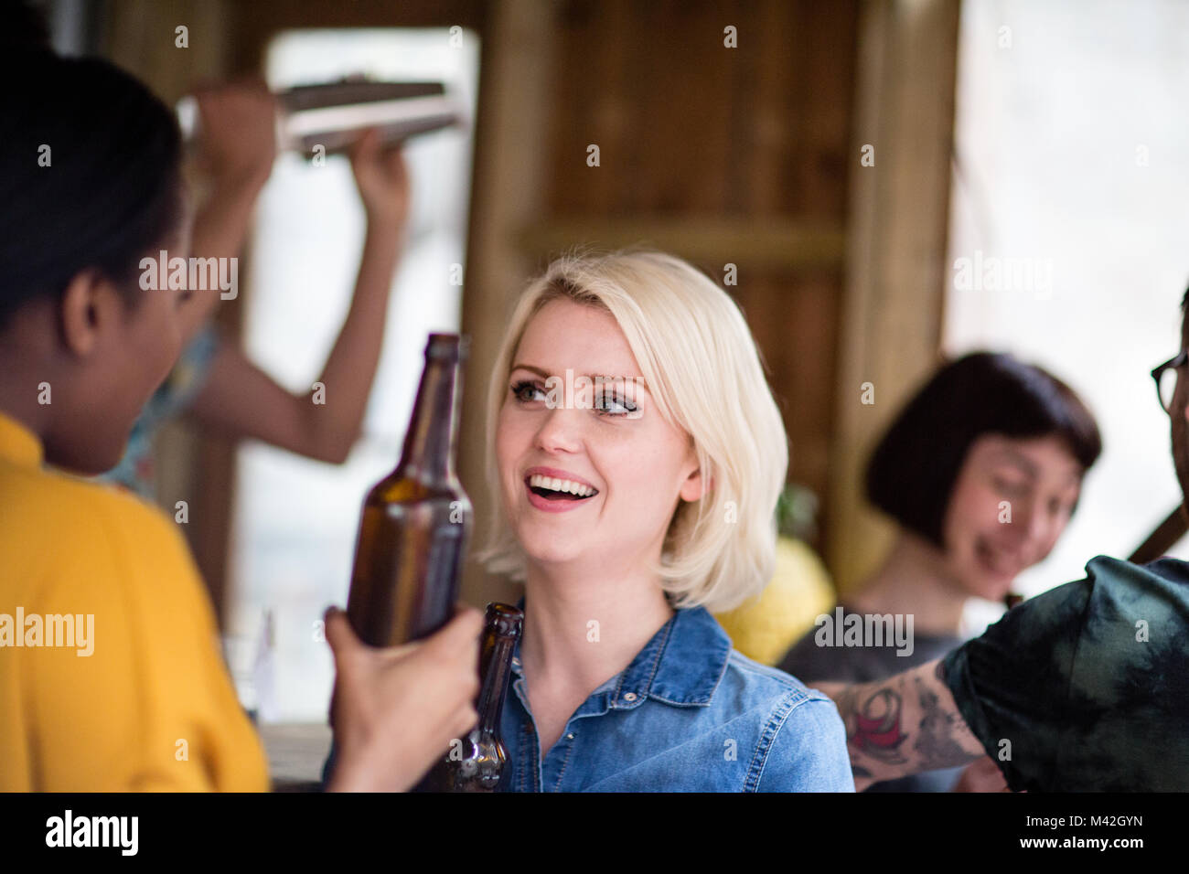 Group of friends at a street food bar drinking beer Stock Photo