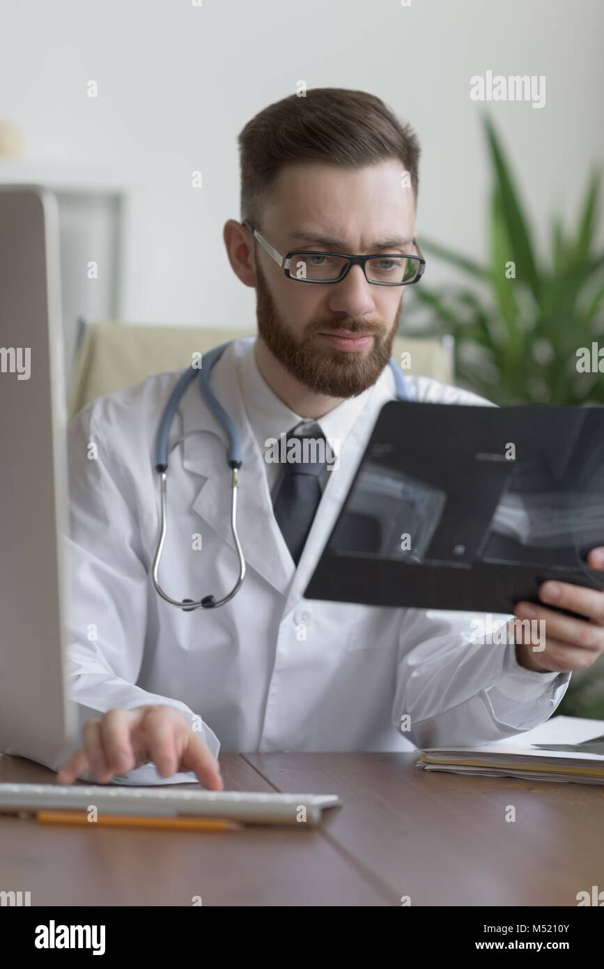 Doctor examining an elbow x-ray. Medicine and healthcare Stock Photo