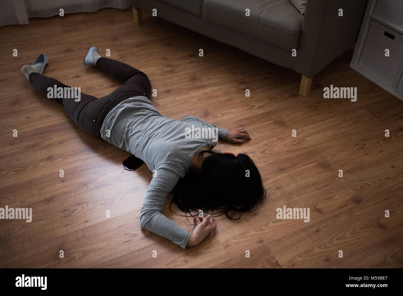 dead woman body in blood on floor at crime scene Stock Photo