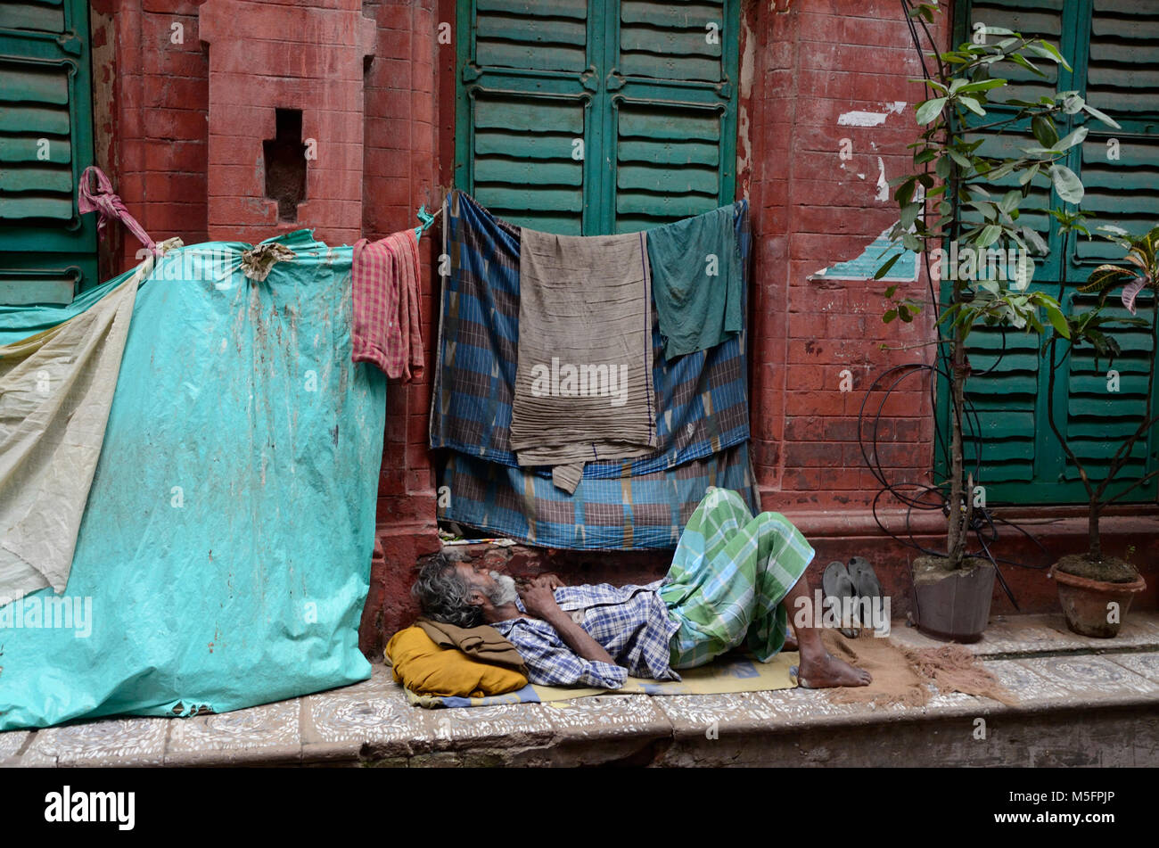 poor man sleeping on pavement, Kolkata, West Bengal, India, Asia Stock Photo