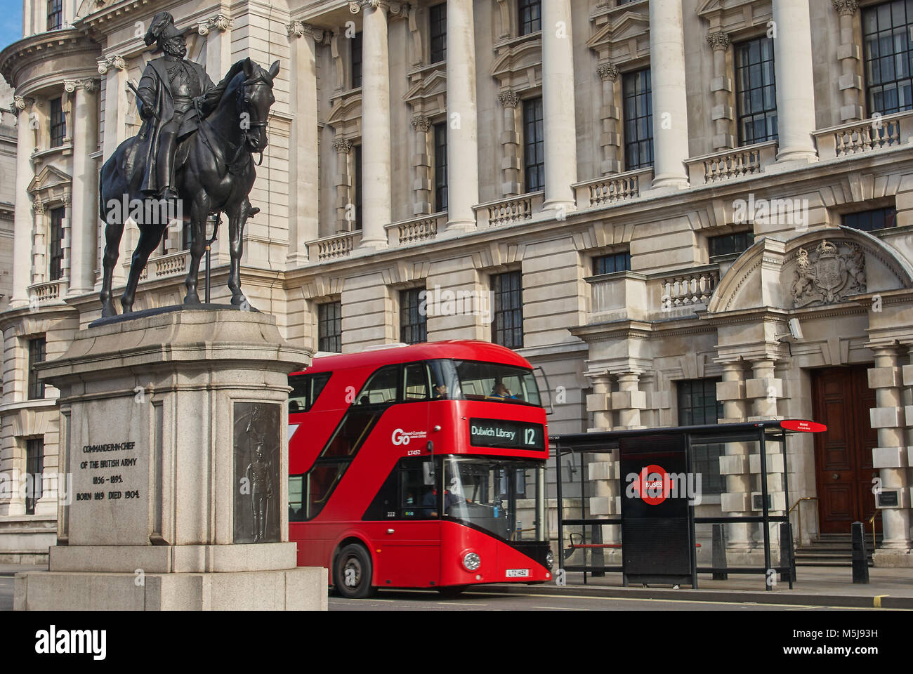 A red double deck bus on Whitehall, London Stock Photo