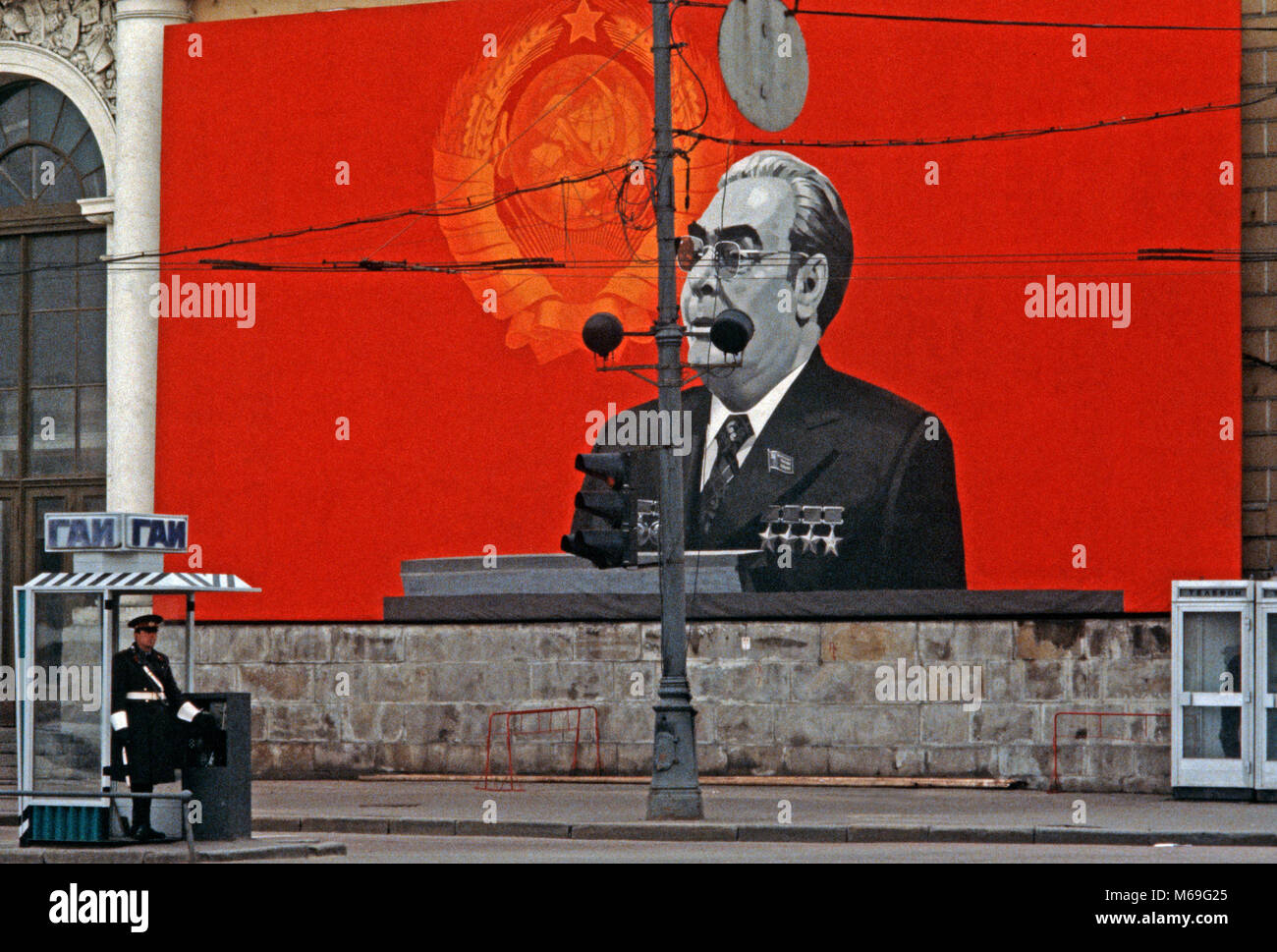 Traffic policeman infront of large poster of Leonid Brezhnev, former General Secretary of the Central Committee of the Communist Party of the Soviet Union, Moscow Russia Stock Photo