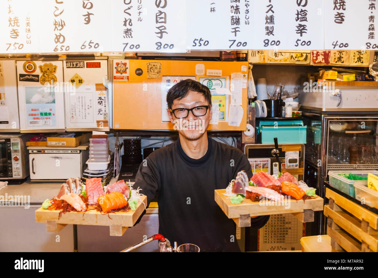 Japan, Honshu, Tokyo, Restaurant Owner Serving Sashimi Stock Photo