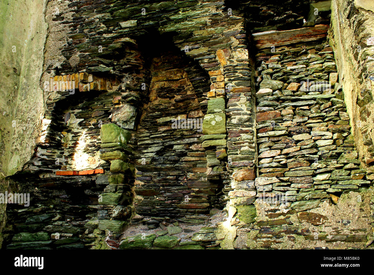 interior of an old watch tower wall, showing the stone work and additions over the years. Stock Photo