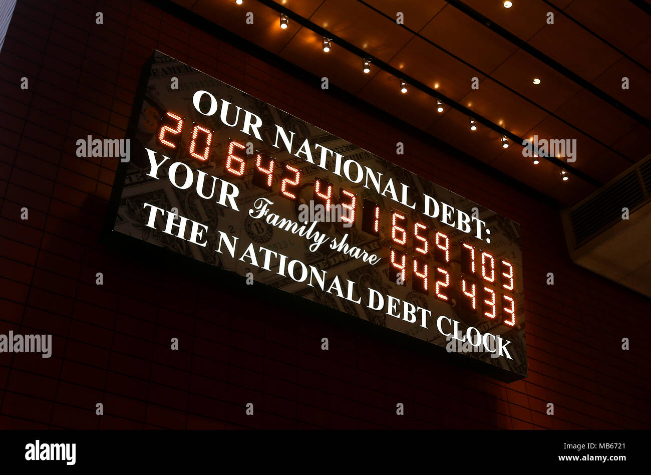 The National Debt Clock just off from Times Square, New York City, USA. The clock shows the ammount of debt owned by USA pictured on March 31 2018. Stock Photo