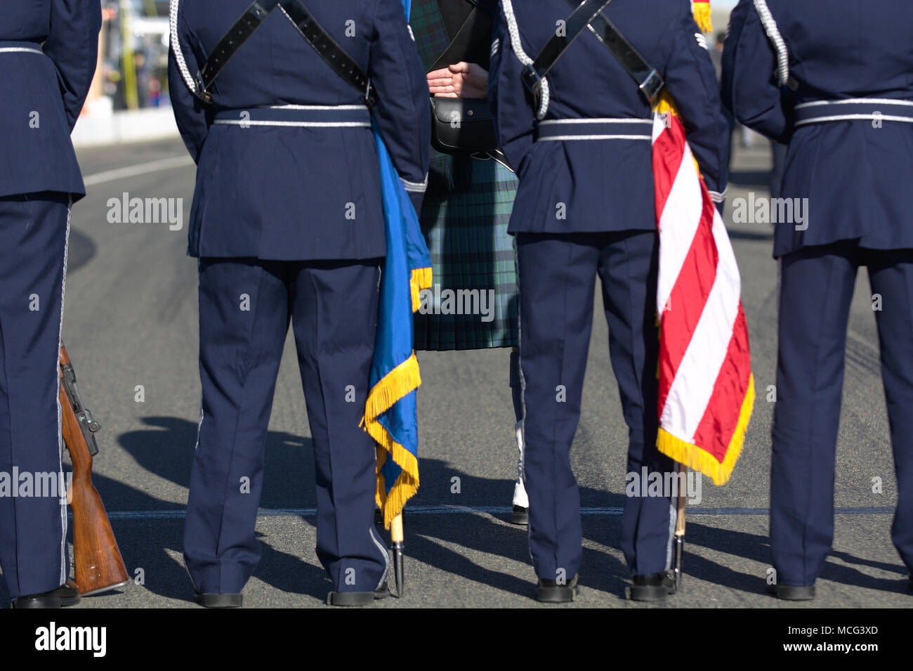 The color guard and a bagpiper stand at parade rest while waiting for the opening ceremony of the 2016 25 Hours of Thunderhill endurance race. Stock Photo