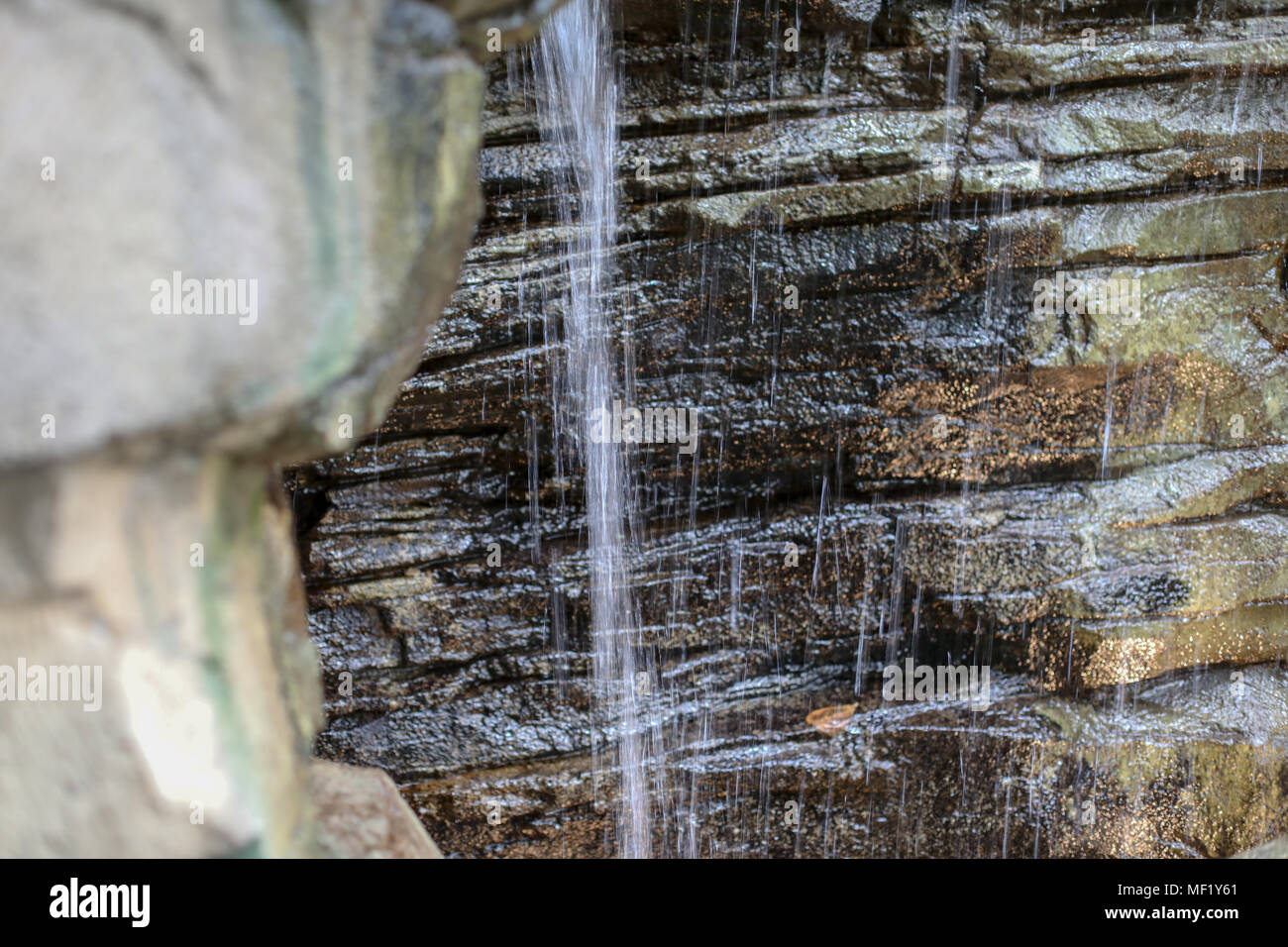 Still life images of small man made waterfall on display at Phipps Conservatory Stock Photo