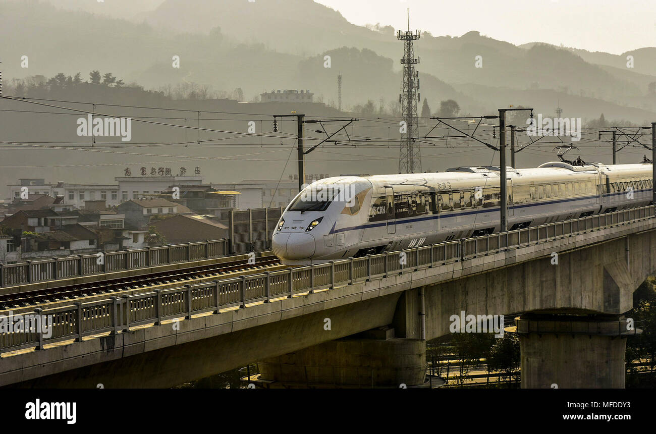 (180425) -- HANZHONG, April 25, 2018 (Xinhua) -- A bullet train passes Gaozhaizi Township in Ningqiang County, northwest China's Shaanxi Province, Nov. 30, 2017. Ningqiang County was hit by a devastating earthquake which centered in Wenchuan County in southwestern China's Sichuan Province on May 12, 2008. After ten years of reconstruction, living conditions has been improved and the economy has rebounded strongly. About 113 resettlement sites were built and about 23,000 families moved into new houses. Some 66 schools were reconstructed and about 268 new village clinics were built. (Xinhua/Li D Stock Photo