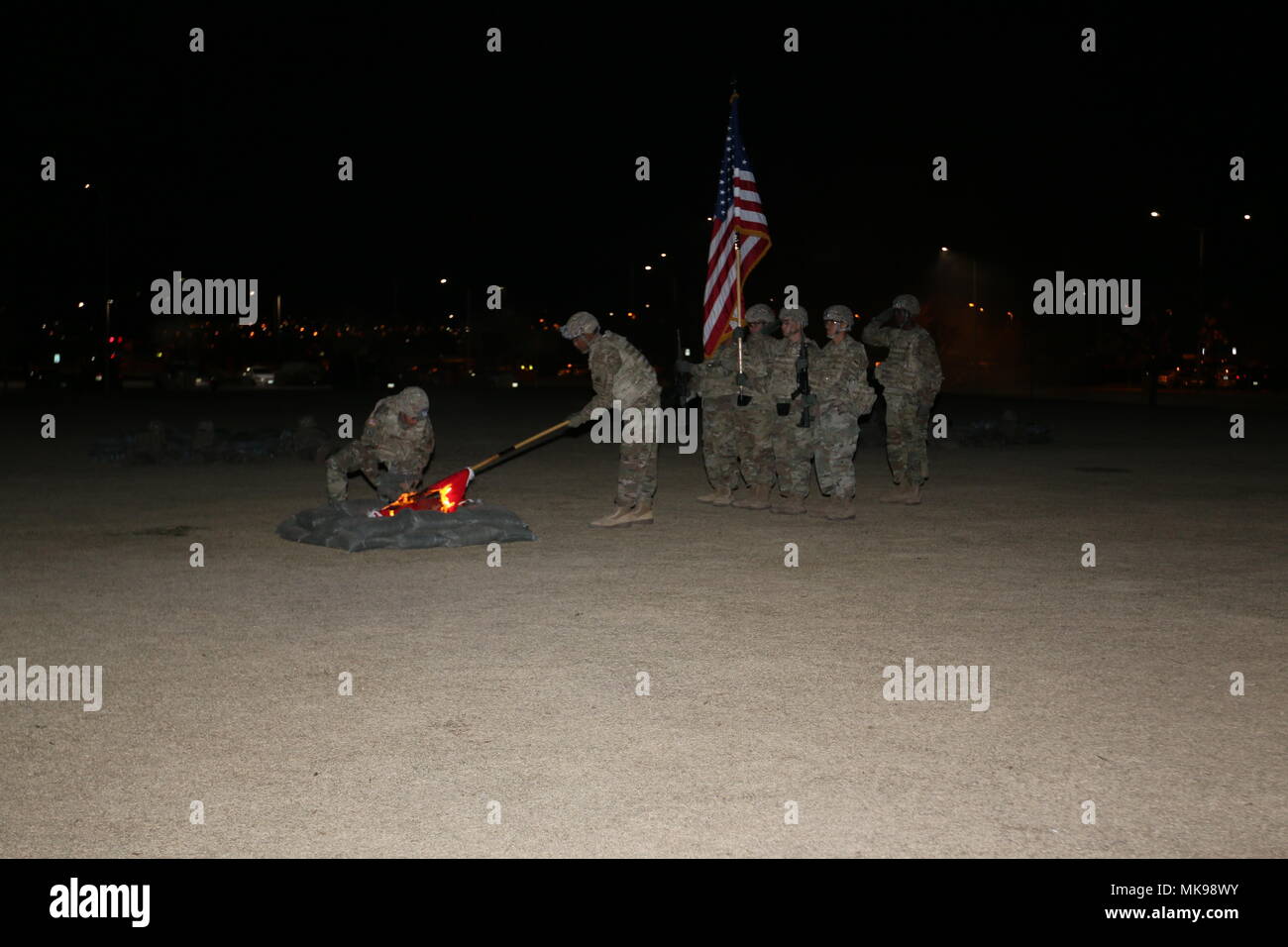 Soldiers with 2nd Engineer Battalion participate in the 67th Anniversary of the Burning of the Colors and a reenactment of the Battle of Kunu-Ri during the Korean War at Bulldog Field, Fort Bliss, Texas, Nov. 30. They put out the flames of the battalion colors after ceremonially burning them, as they did in 1950. (U.S. Army Photo by Staff Sgt. Felicia Jagdatt) Stock Photo