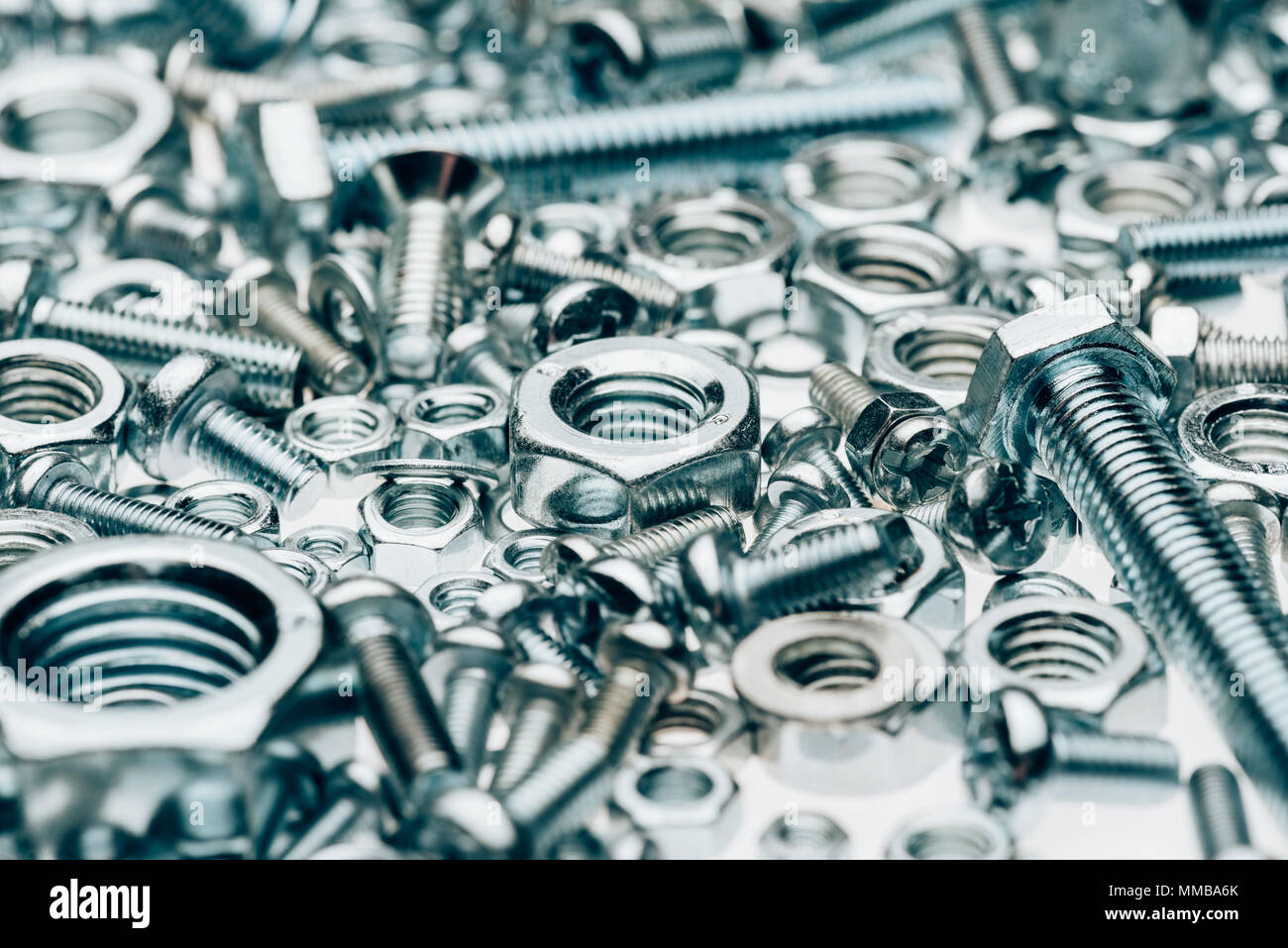 close up view of metal framing nails and capscrews isolated on white Stock Photo