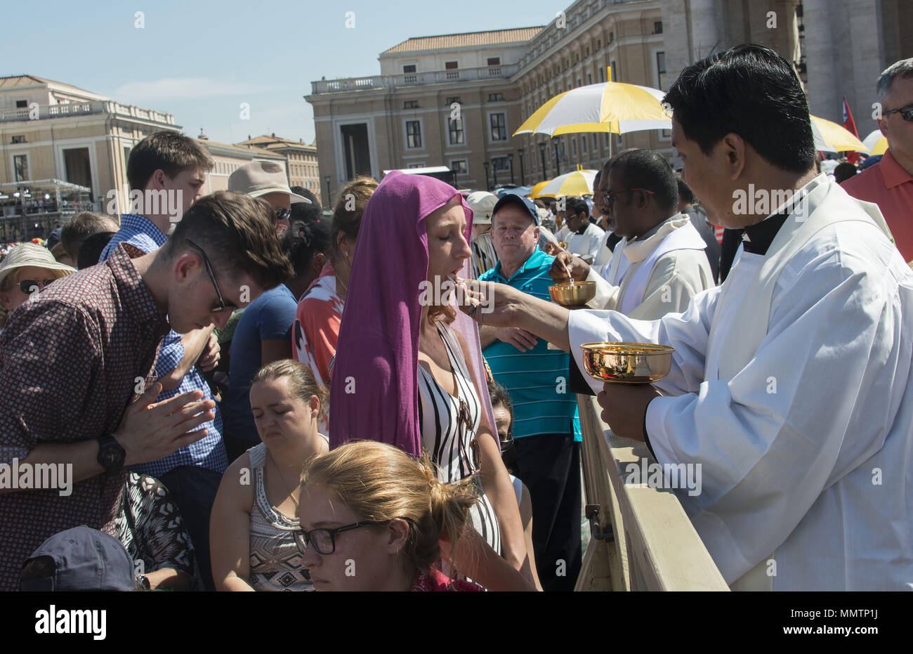 Priests giving communion at the canonisation of Mother Teresa in Rome Stock Photo