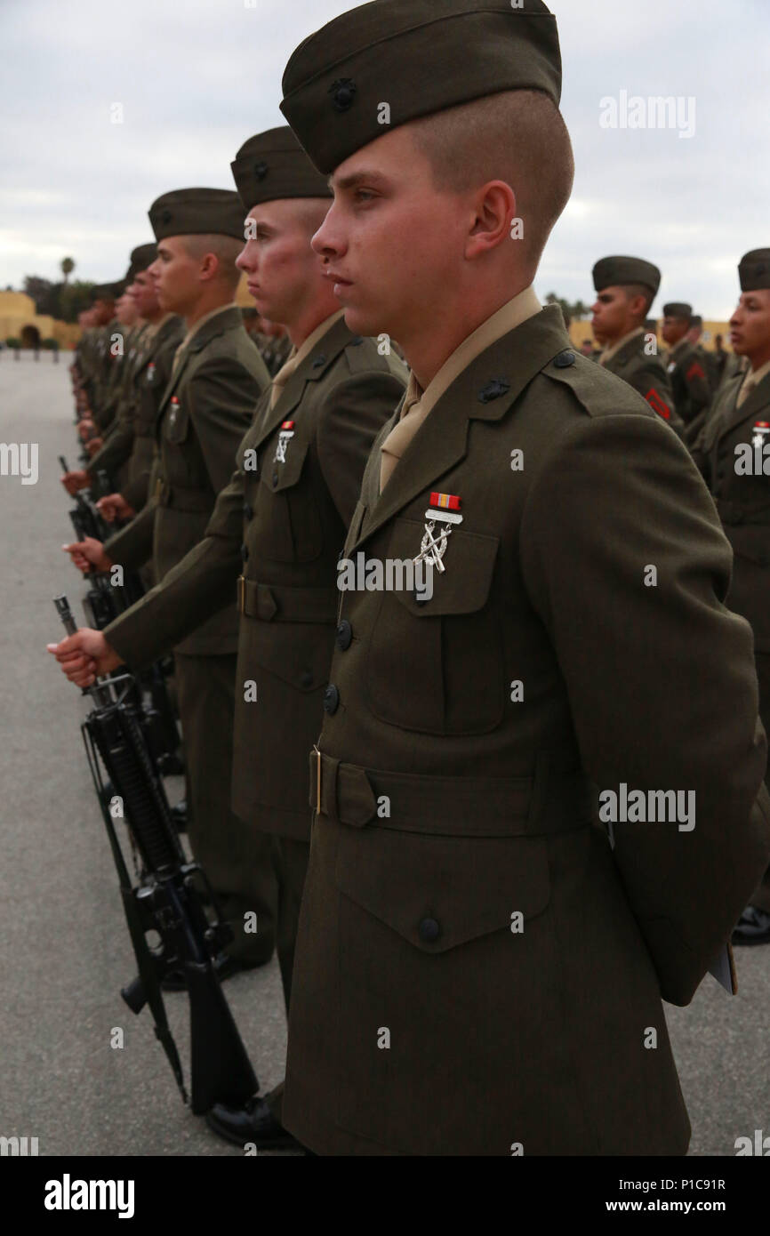 Marines from Bravo Company, 1st Recruit Training Battalion, stand at parade rest during the Battalion Commander’s Inspection at Marine Corps Recruit Depot San Diego, Oct. 11. The inspection included checking the cleanliness and readiness of their weapons and form and fit of uniforms. Annually, more than 17,000 males recruited from the Western Recruiting Region are trained at MCRD San Diego. Bravo Company is scheduled to graduate Oct. 14. Stock Photo