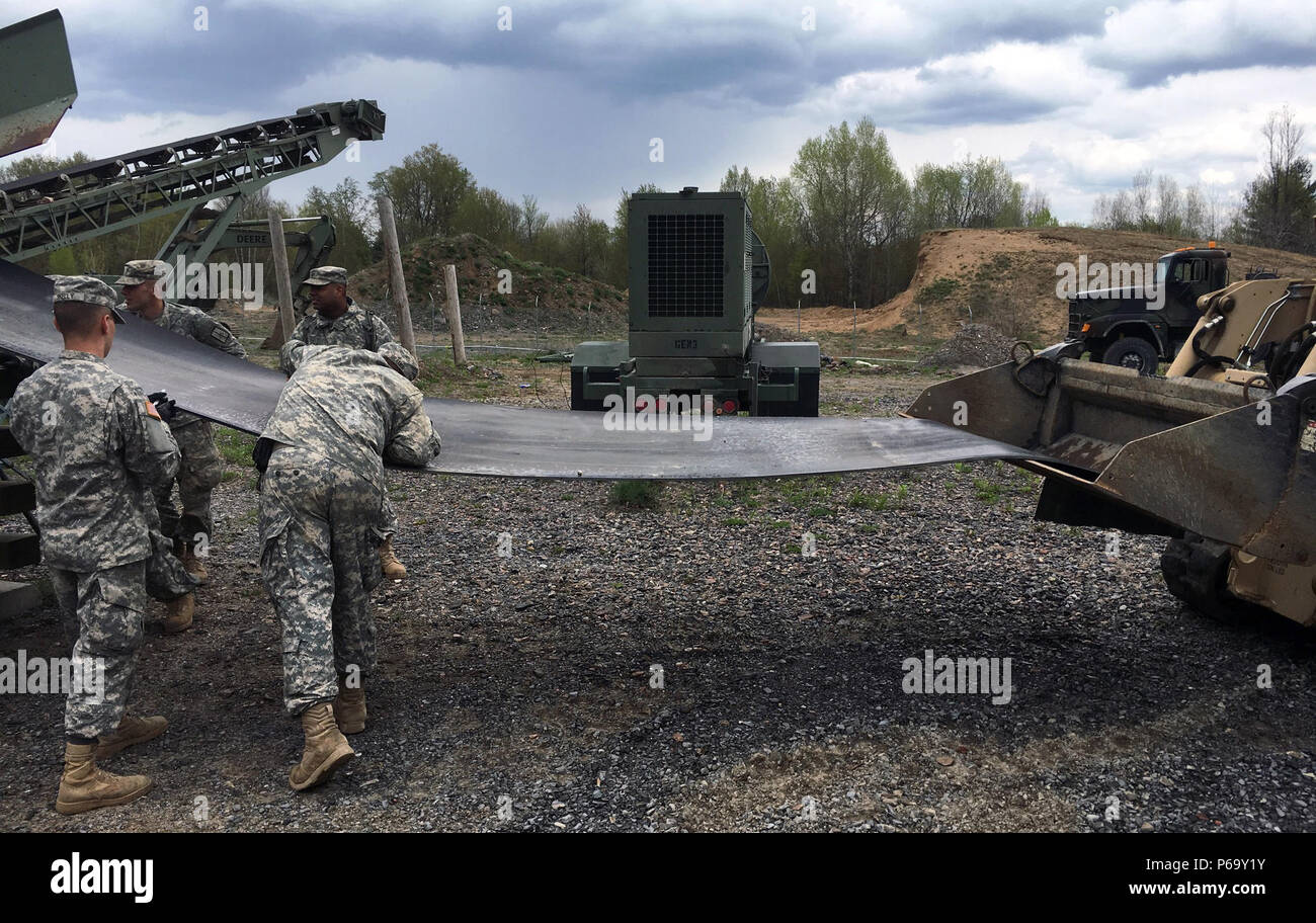 Fort Drum, N.Y. -- Troops of the New York Army National Guard’s 204th Engineer Detachment (Quarry) remove a failing conveyor belt from a quarry machine called a “crusher” here on May 14. Operating the crusher, which can turn large rocks into various grades of construction material, is the detachment’s main mission. Soldiers of the detachment, which is based in Binghamton, N.Y., worked for about 10 hours on May 14 to fix several mechanical shortfalls and ensure the crusher is operational for the detachment’s annual training in July. (U.S. Army National Guard photo by Sgt. 1st Class Jason Lehman Stock Photo