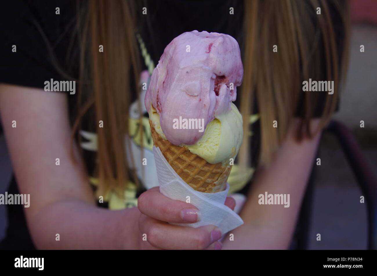 Girl is holding a tasty ice cream on a hot day Stock Photo