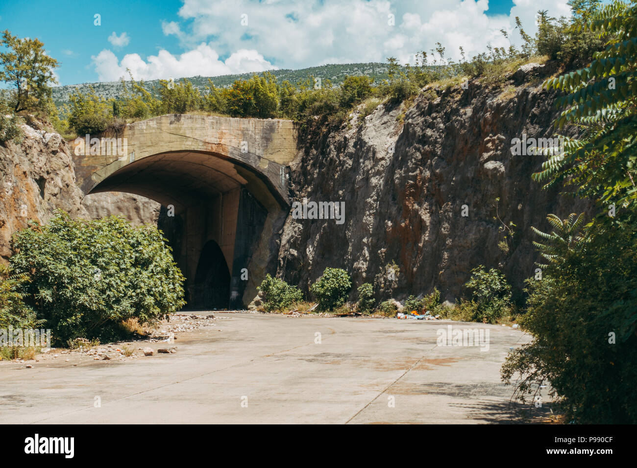 an abandoned hangar at Mostar Airport, BiH. During the Bosnian war, up to 10 fighter aircraft were housed in here, protected by the mountainside Stock Photo