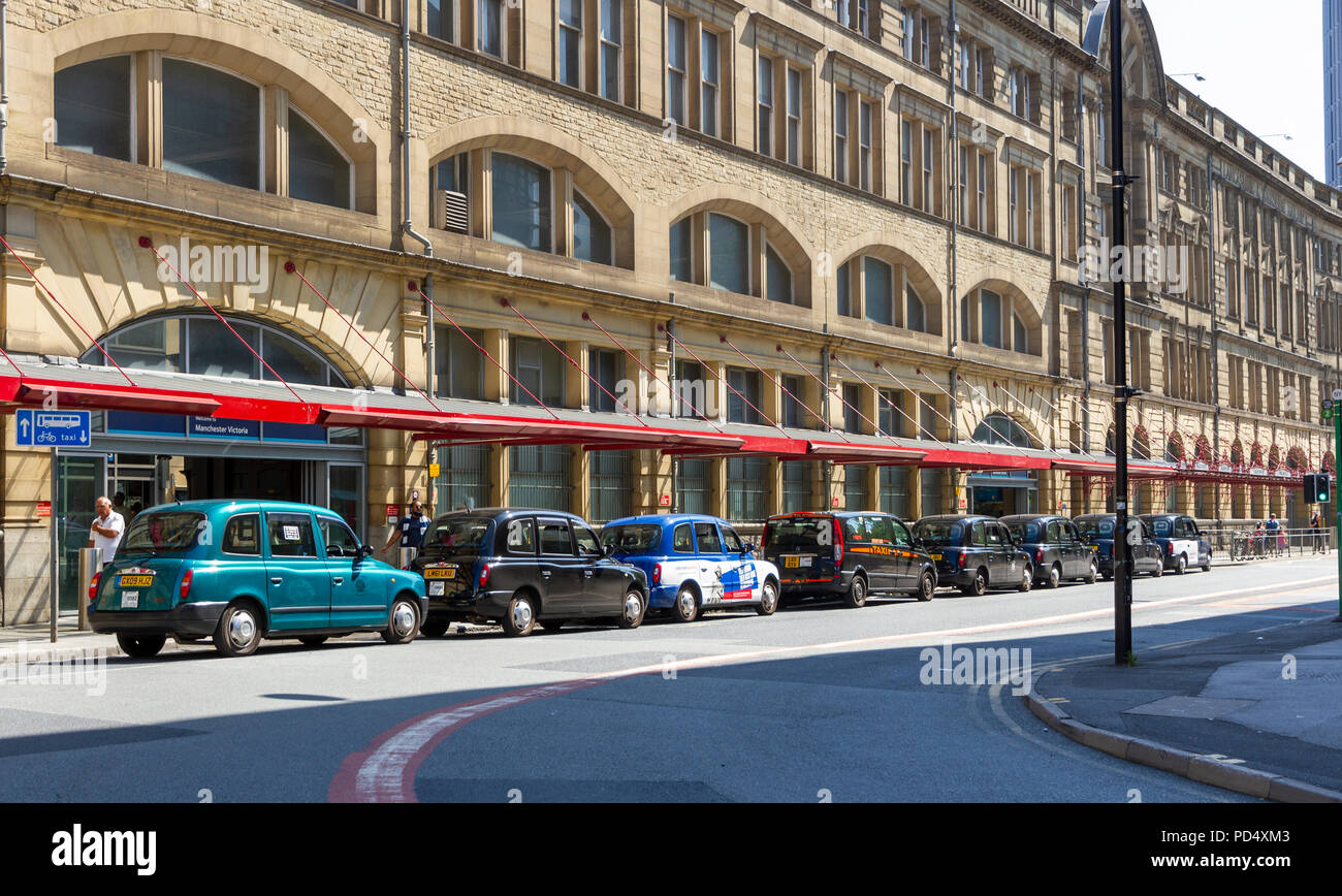 Taxi cabs lined up outside Victoria Train Station Manchester Stock Photo