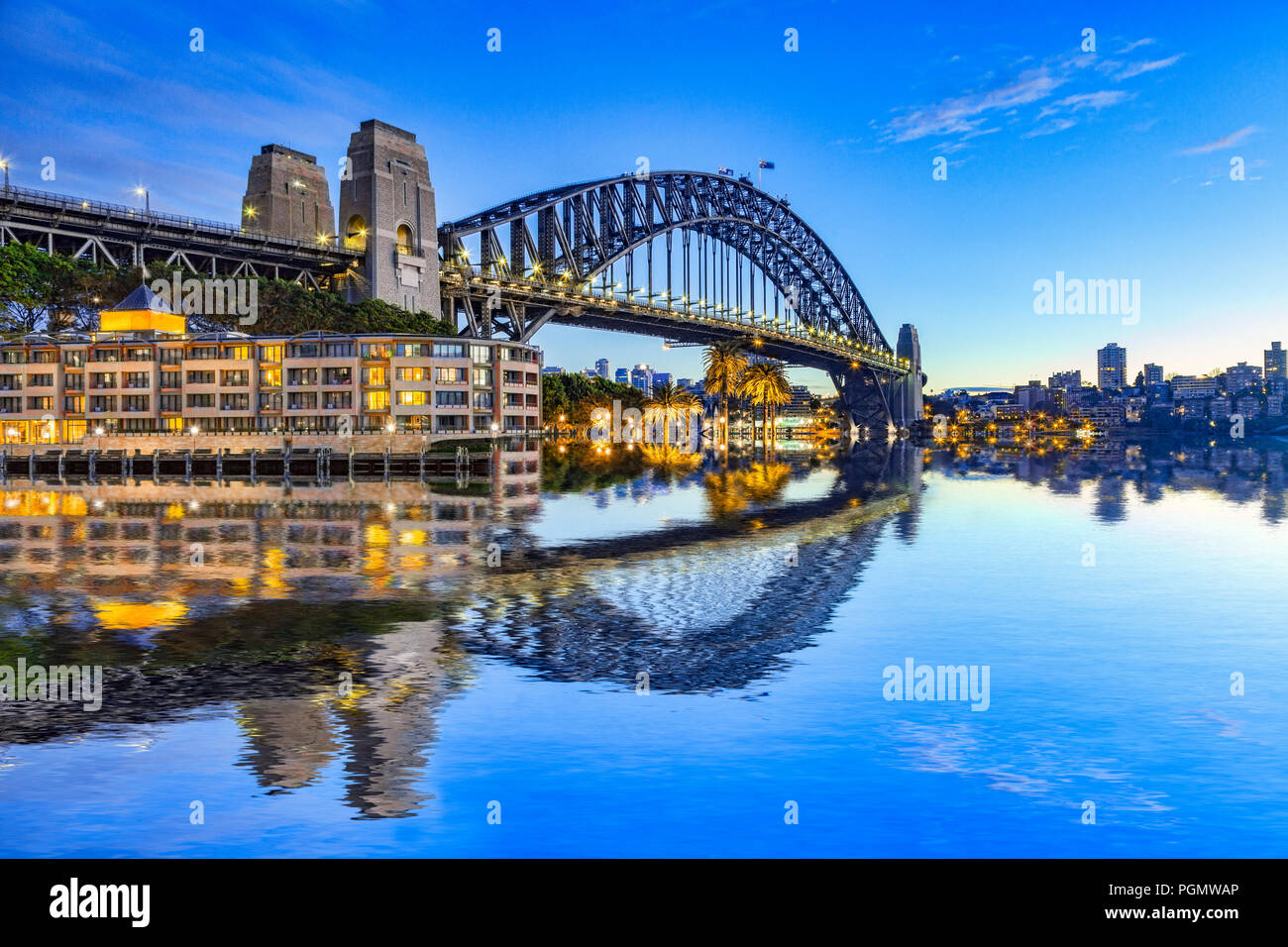 Sydney Harbour Bridge, reflected in the waters of the harbour, and North Sydney. Stock Photo