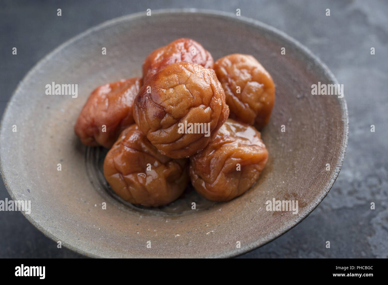 Traditional Japanese Umeboshi as close-up in a bowl Stock Photo