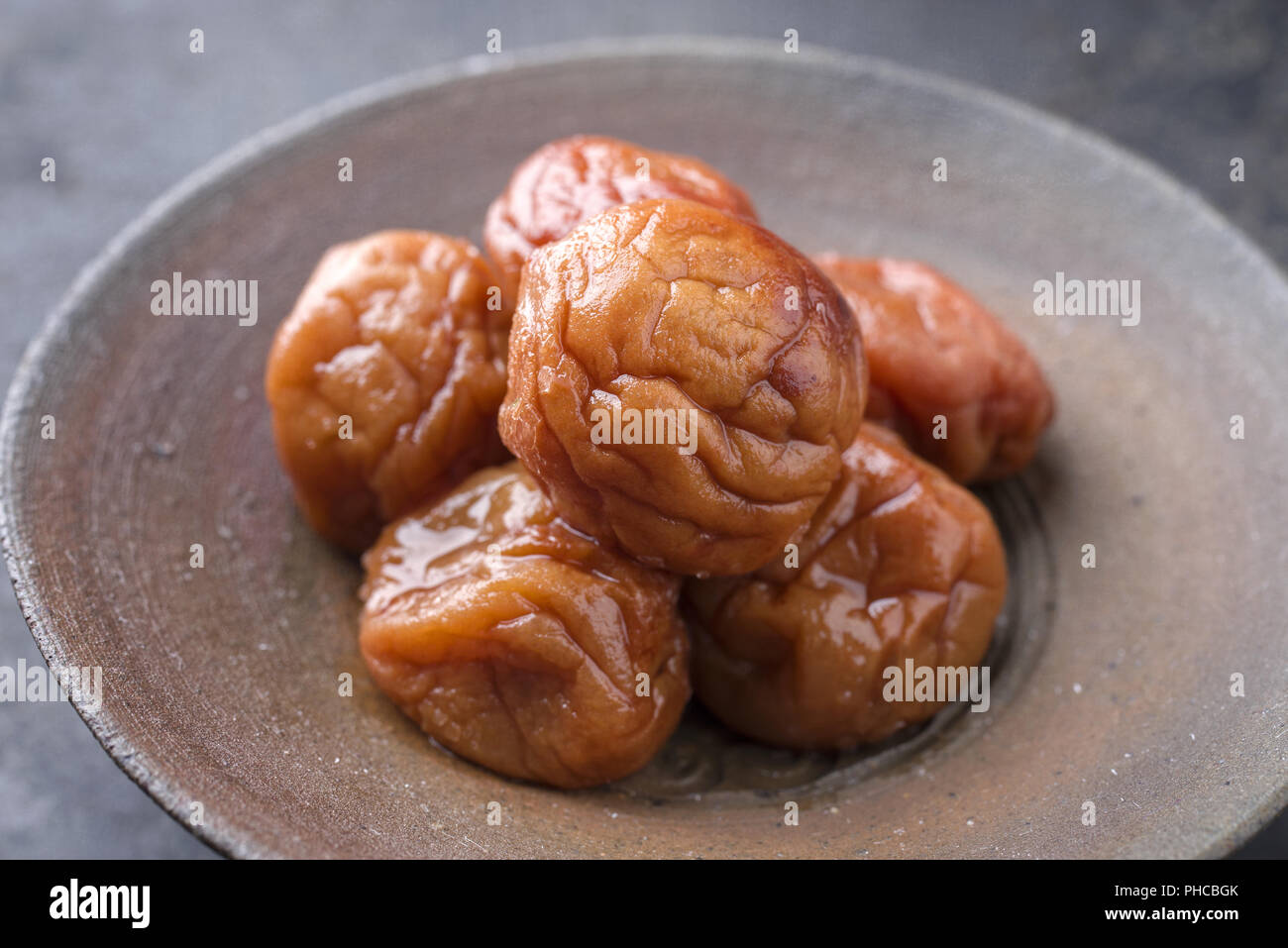 Traditional Japanese Umeboshi as close-up in a bowl Stock Photo