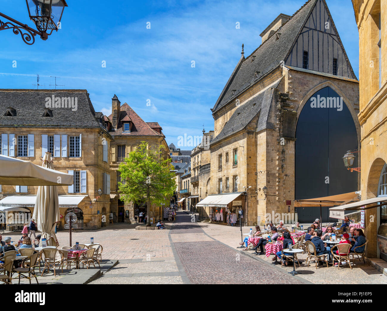 Cafes on Place de la Liberte looking towards Old St. Mary's Church, Sarlat, Dordogne, France Stock Photo