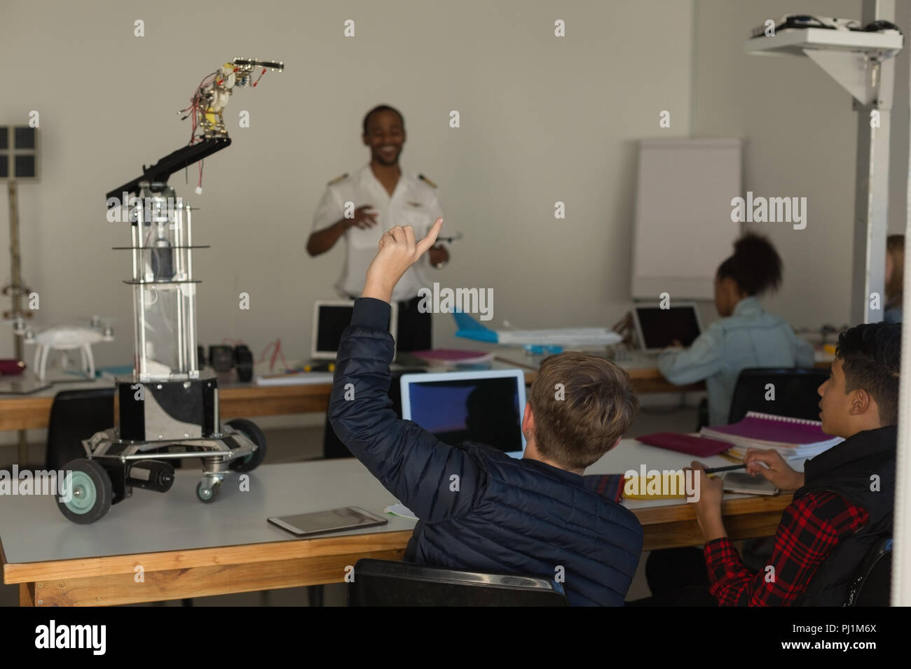 Student asking query to the trainer Stock Photo