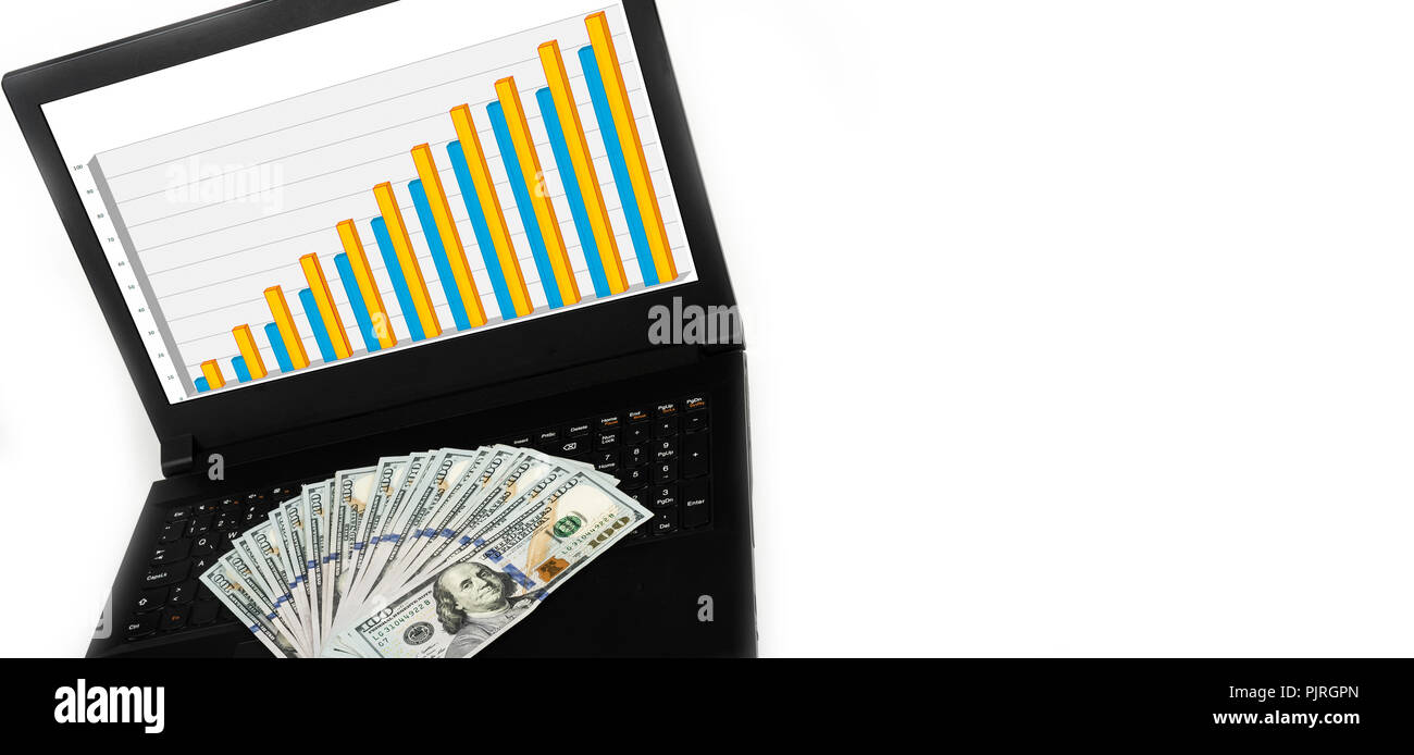 Laptop or notebook with widespread of cash money isolated on white background with bar chart graph on display. Stock Photo