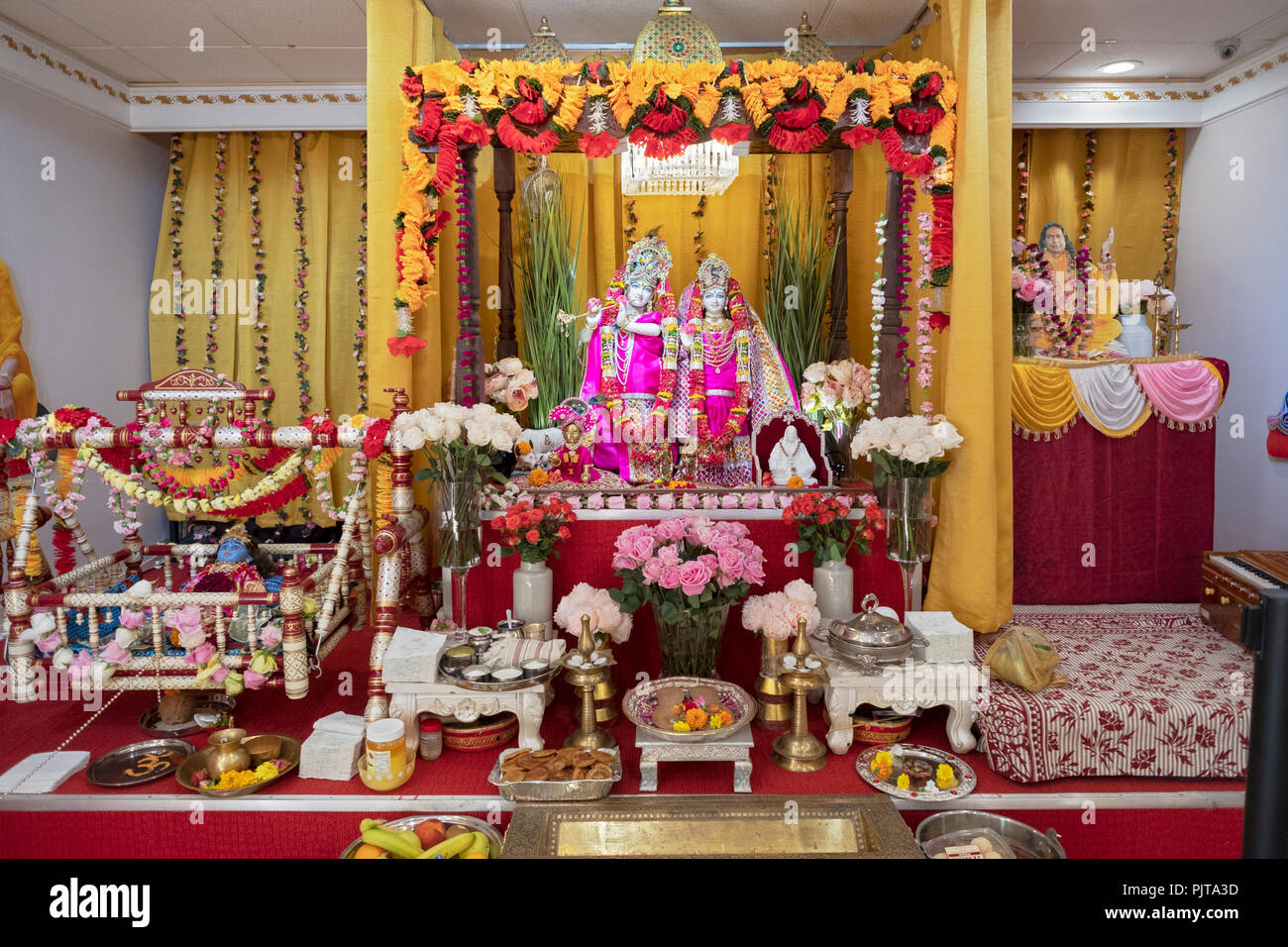 The alter with statues of deities decorated for Janmashtami Temple Radha Govind Dham in Glen Oak, Queens, New York. Stock Photo