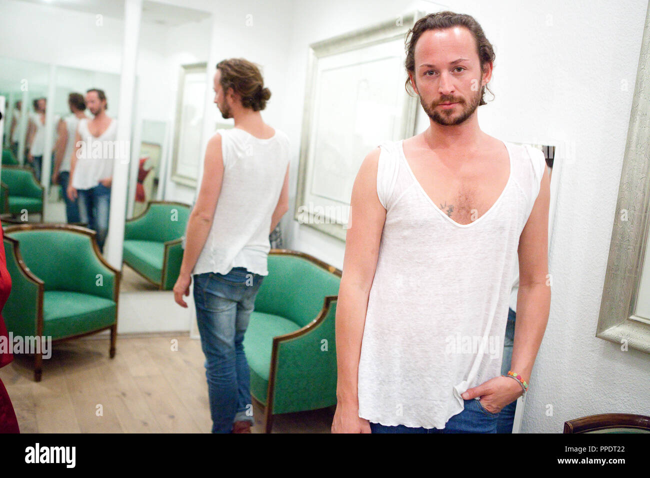 Fashion designer Marcel Ostertag in comfortable clothes in his studio in the Rumfordstrasse in the Gaertnerplatzviertel in Munich. Stock Photo