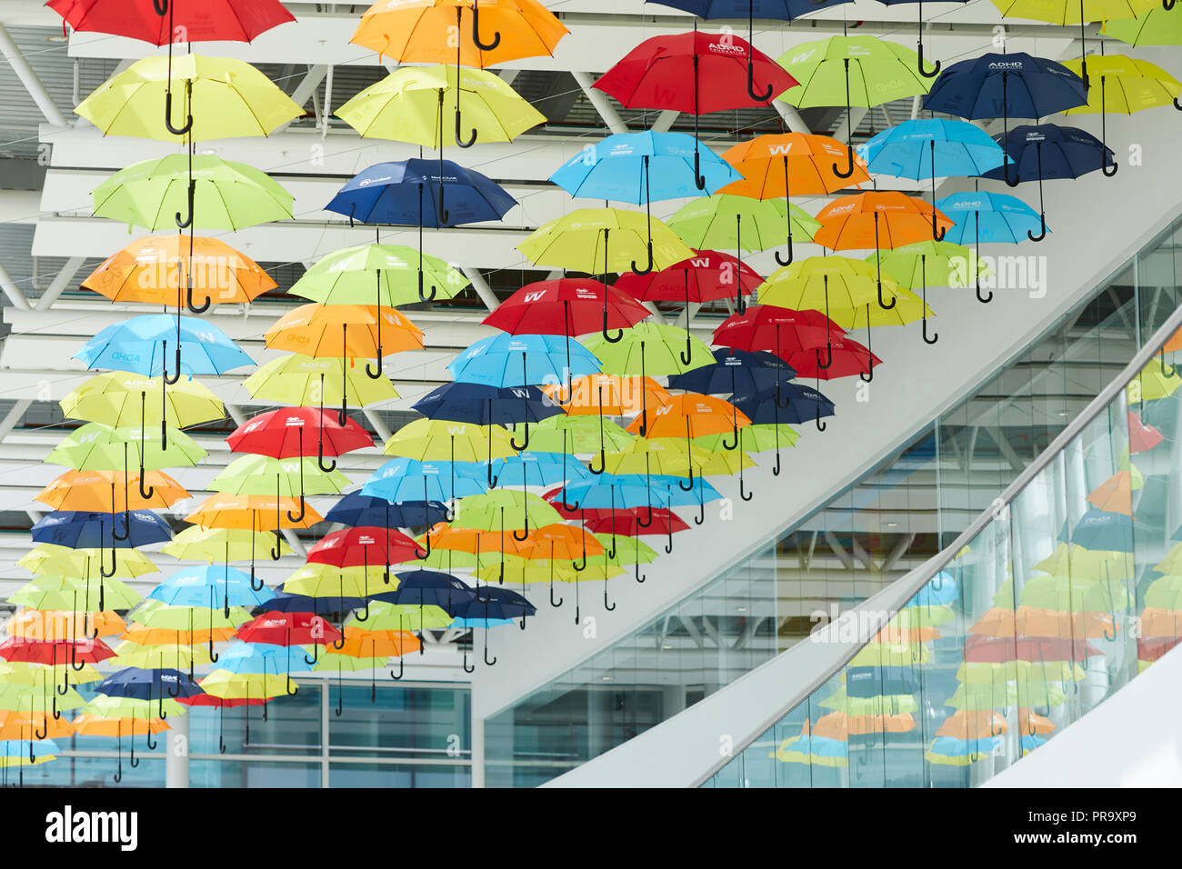 Brightly coloured umbrellas suspended in MediaCityUK Salford Quays to raise awareness of Attention Deficit Hyperactivity Disorder (ADHD) and autism Stock Photo