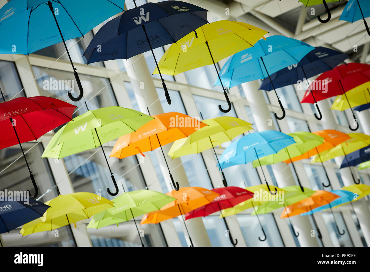 Brightly coloured umbrellas suspended in MediaCityUK Salford Quays to raise awareness of Attention Deficit Hyperactivity Disorder (ADHD) and autism Stock Photo