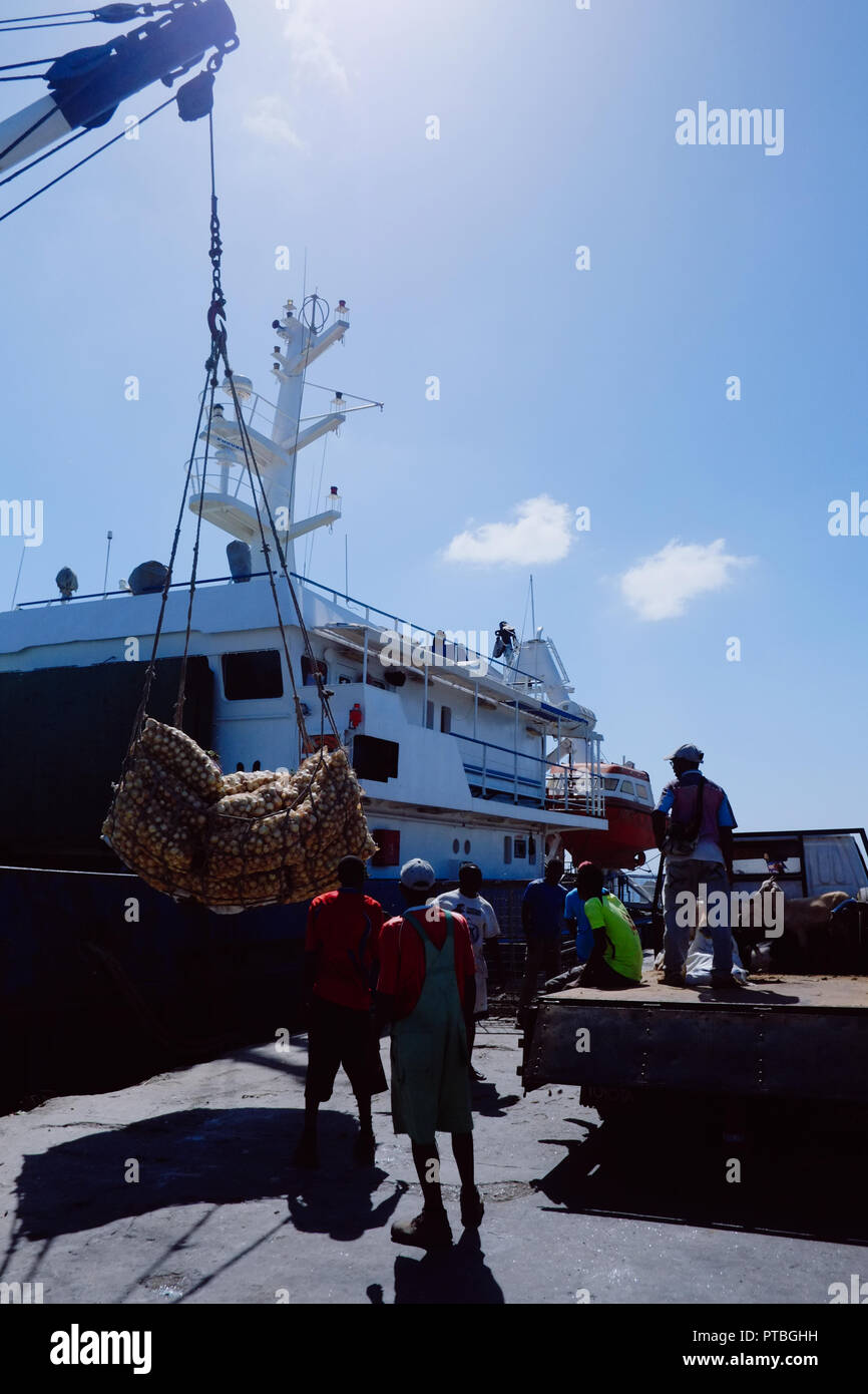 Vila do Maio ,Maio Island, Cape Verde - Jan 5 2016: cargo ship crew is offloading the goods arrived to the harbor Stock Photo