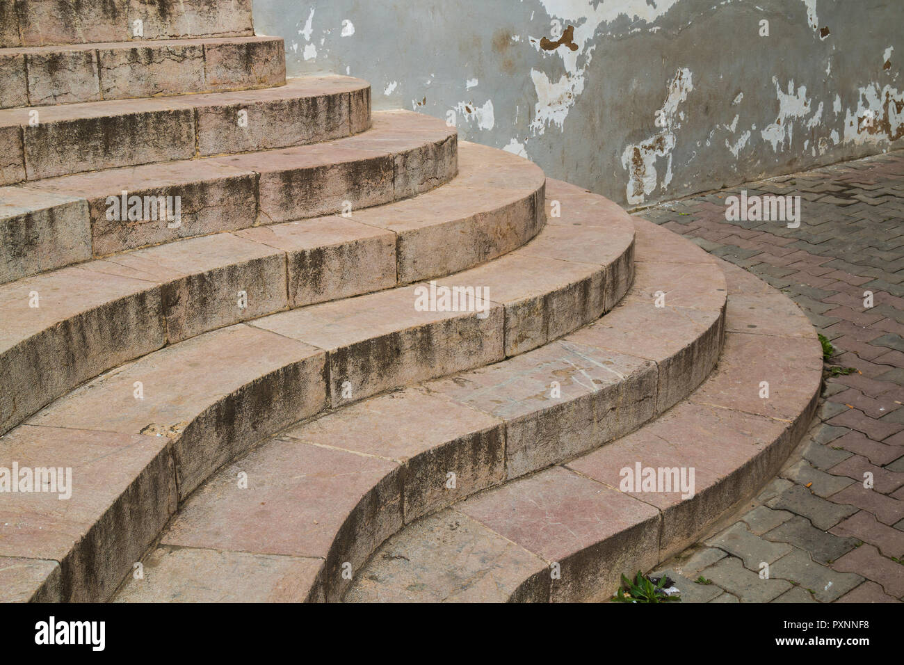 Marble stairs designed to a curves. Entrance to a building. Pavement with cobblestones. Old wall. Sale - Rabat, Morocco. Stock Photo