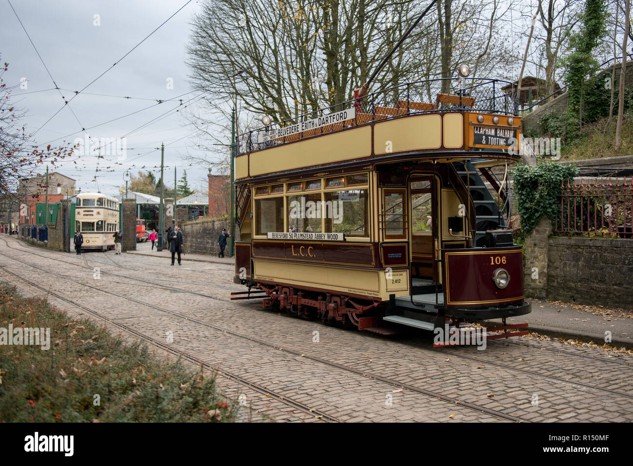 Vintage South East London and Sheffield tram in the background on route at Crich Tramway Village, Derbyshire, UK Stock Photo