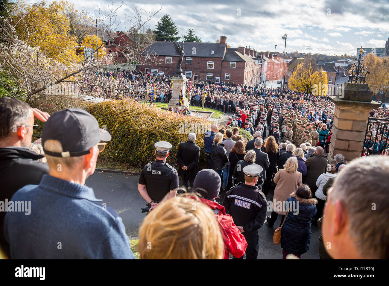 Kidderminster, UK. 11th November, 2018. With acts of remembrance taking place worldwide today, the people of Kidderminster come out in their hundreds to commemorate those who gave their lives for their country. On a gloriously sunny morning, crowds congregate at St Mary and All Saints Church, circling The Angel of Peace war memorial to pay their respects. Credit: Lee Hudson/Alamy Live News Stock Photo