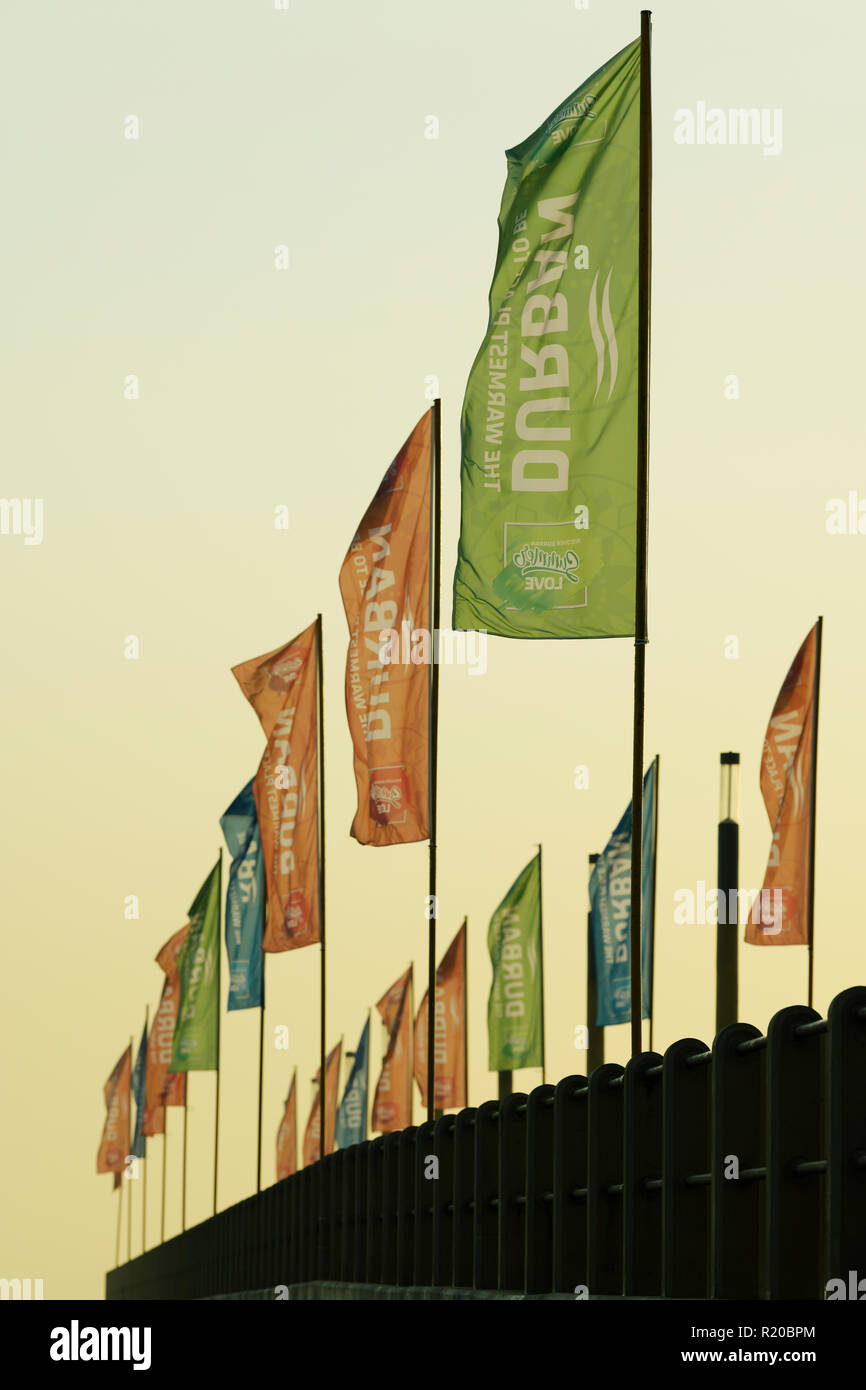 Durban, KwaZulu-Natal, South Africa, colourful rows of branded flags marketing city of Durban on pier, back lighting in early morning sunshine, Stock Photo