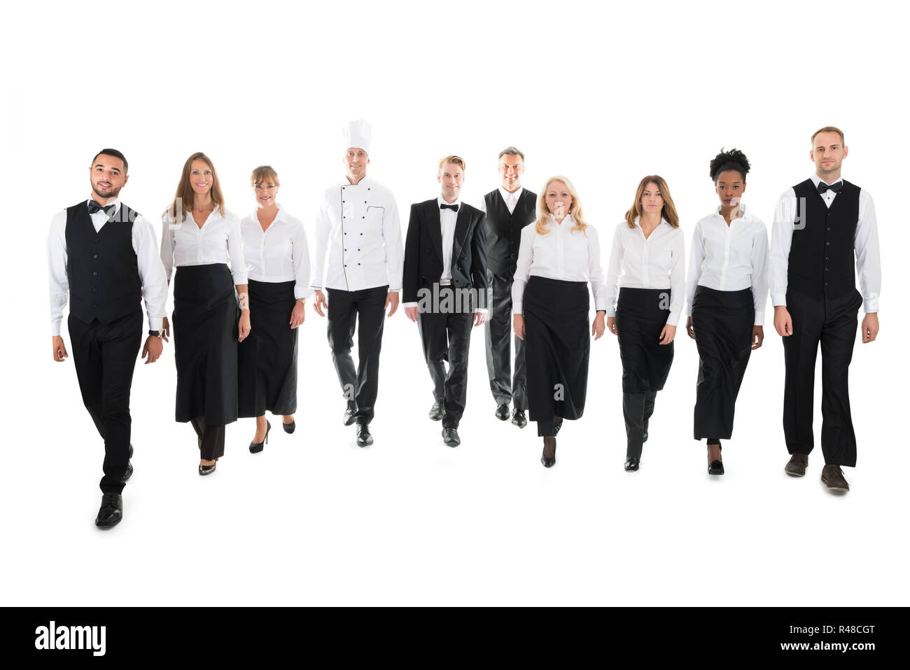 Portrait Of Confident Restaurant Staff Walking Stock Photo