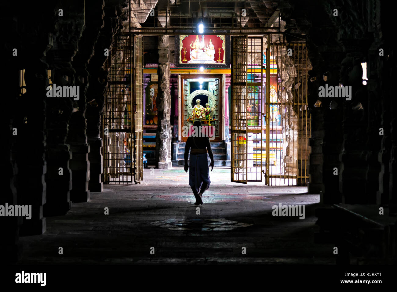 Kanchipuram, India - August 19, 2018: A brahmin walking to a hindu shrine inside the Ekambareswarar temple in Tamil Nadu state Stock Photo