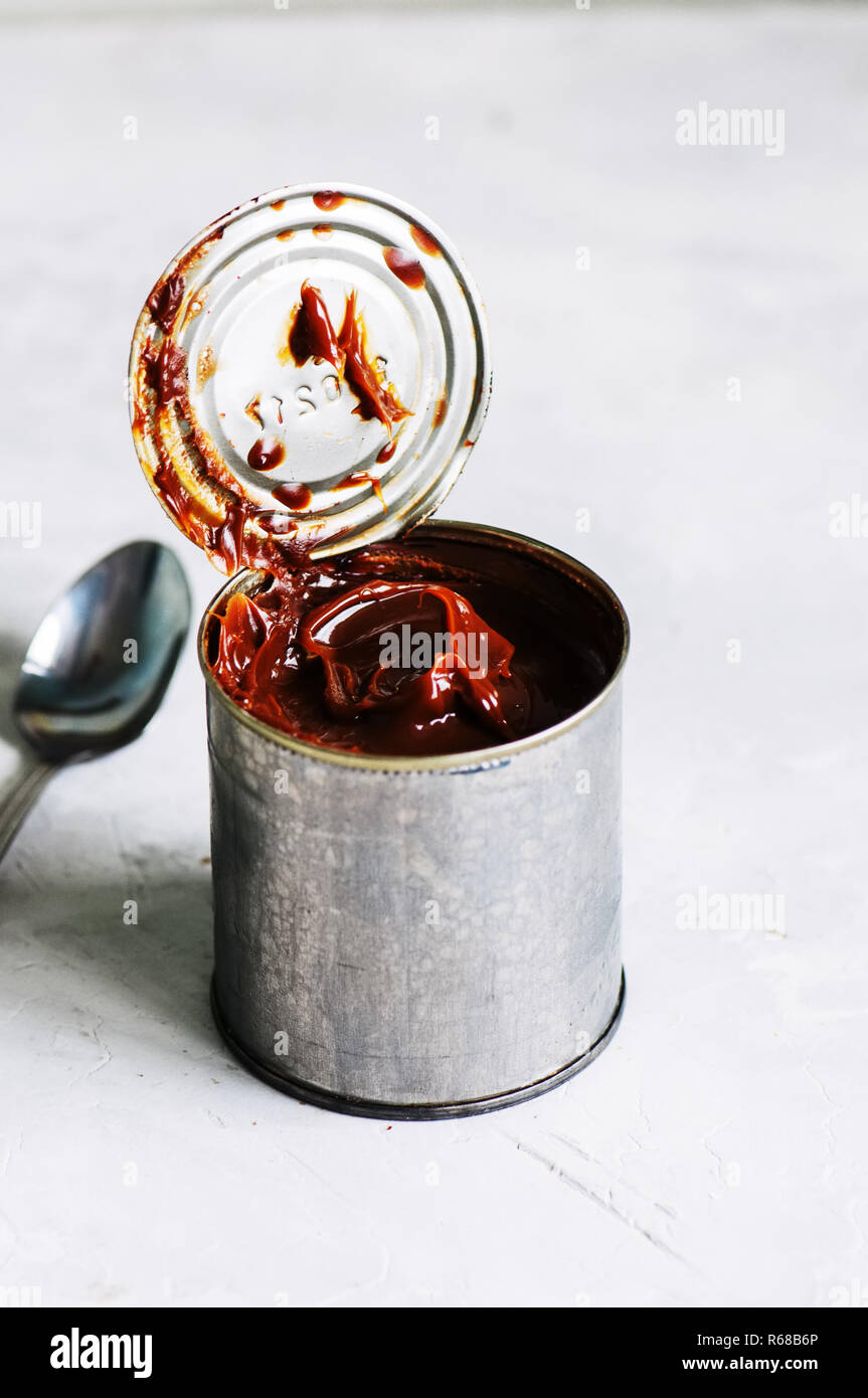 Close up of dulce de leche caramel in a can tin. Stock Photo