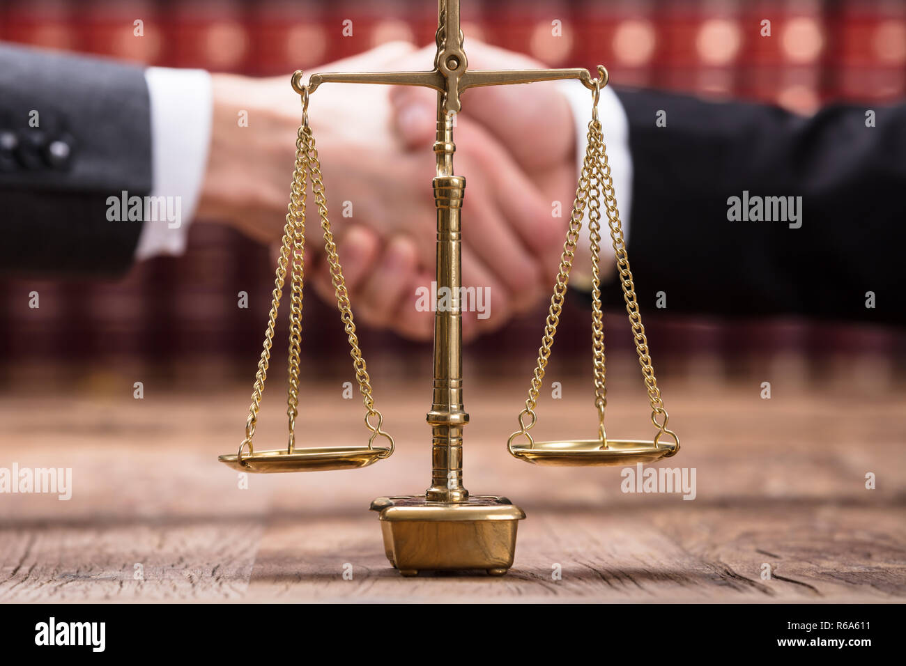 Close-up Of Justice Scale On Wooden Desk Stock Photo