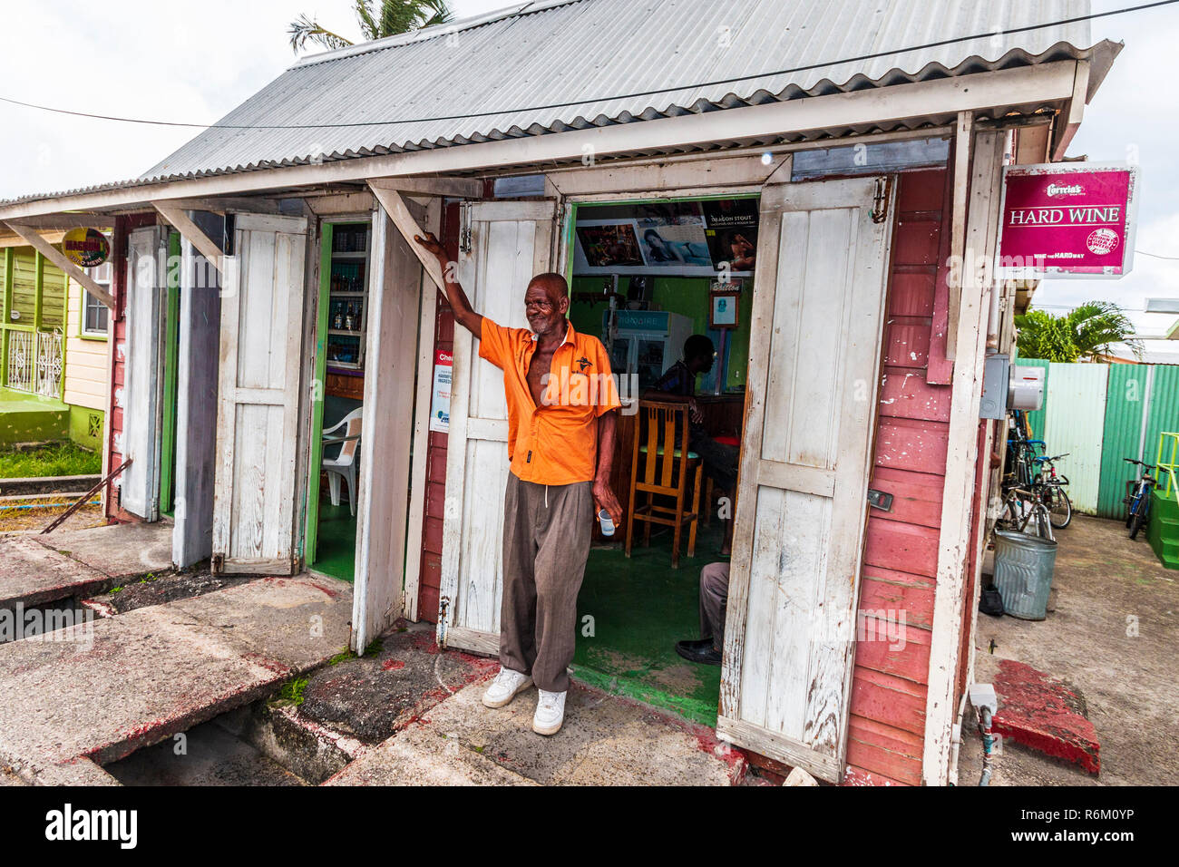 Local elderly man outside a rum shop in Bridgetown, Barbados in the Caribbean. Stock Photo