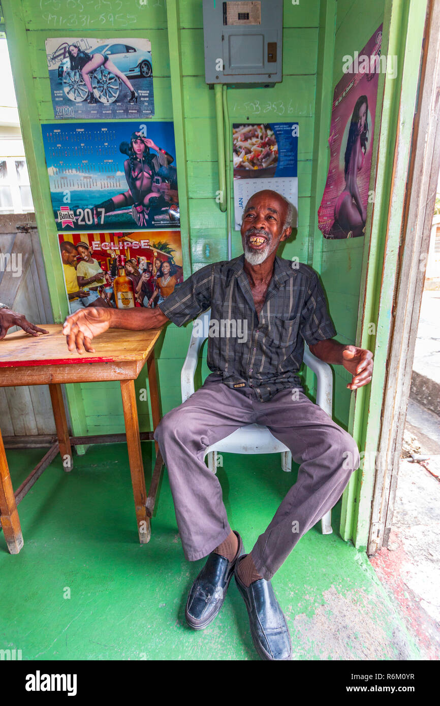 Local elderly man inside a rum shop in Bridgetown, Barbados in the Caribbean. Stock Photo