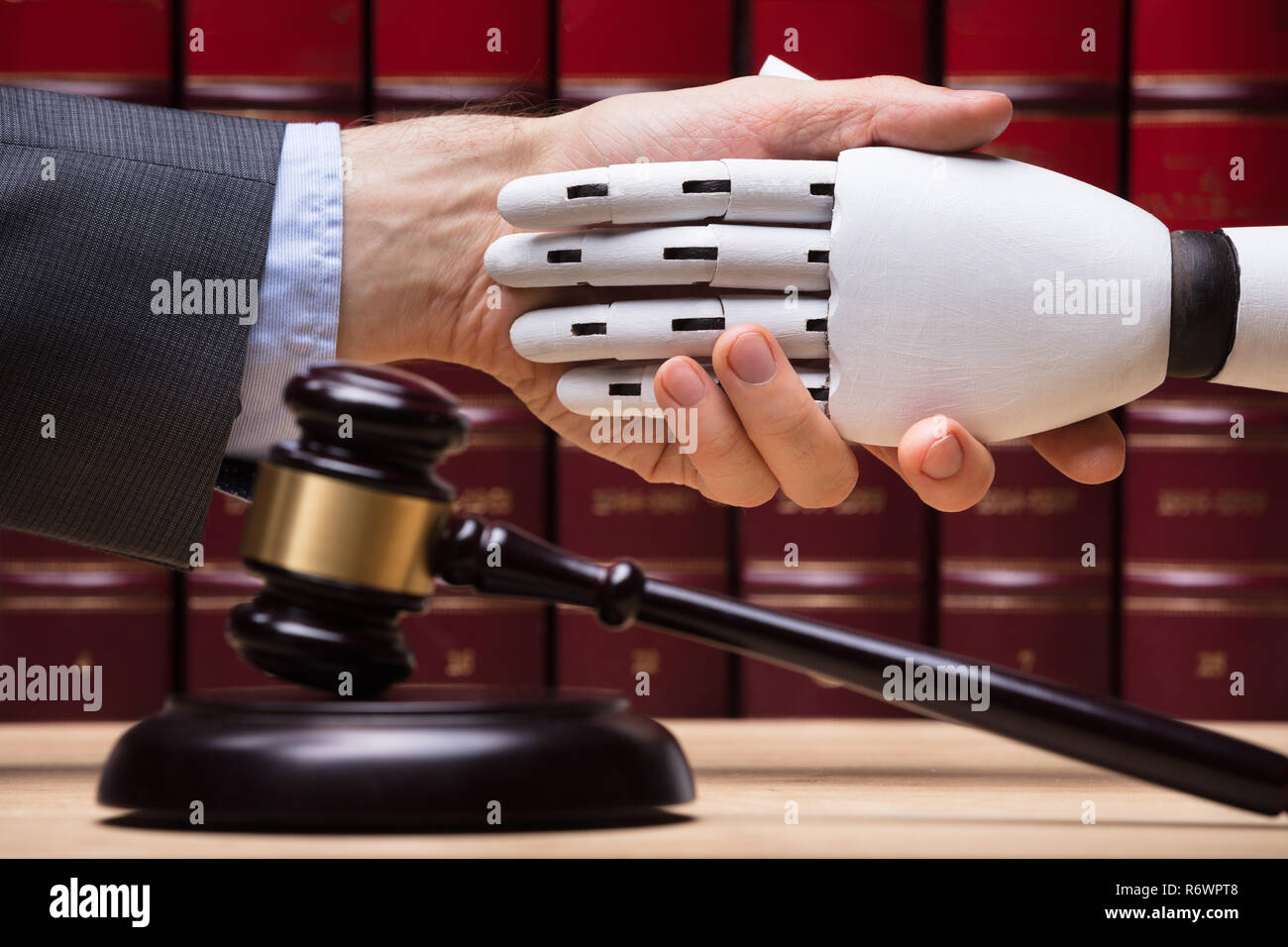 Robot Shaking Hands With Judge Stock Photo